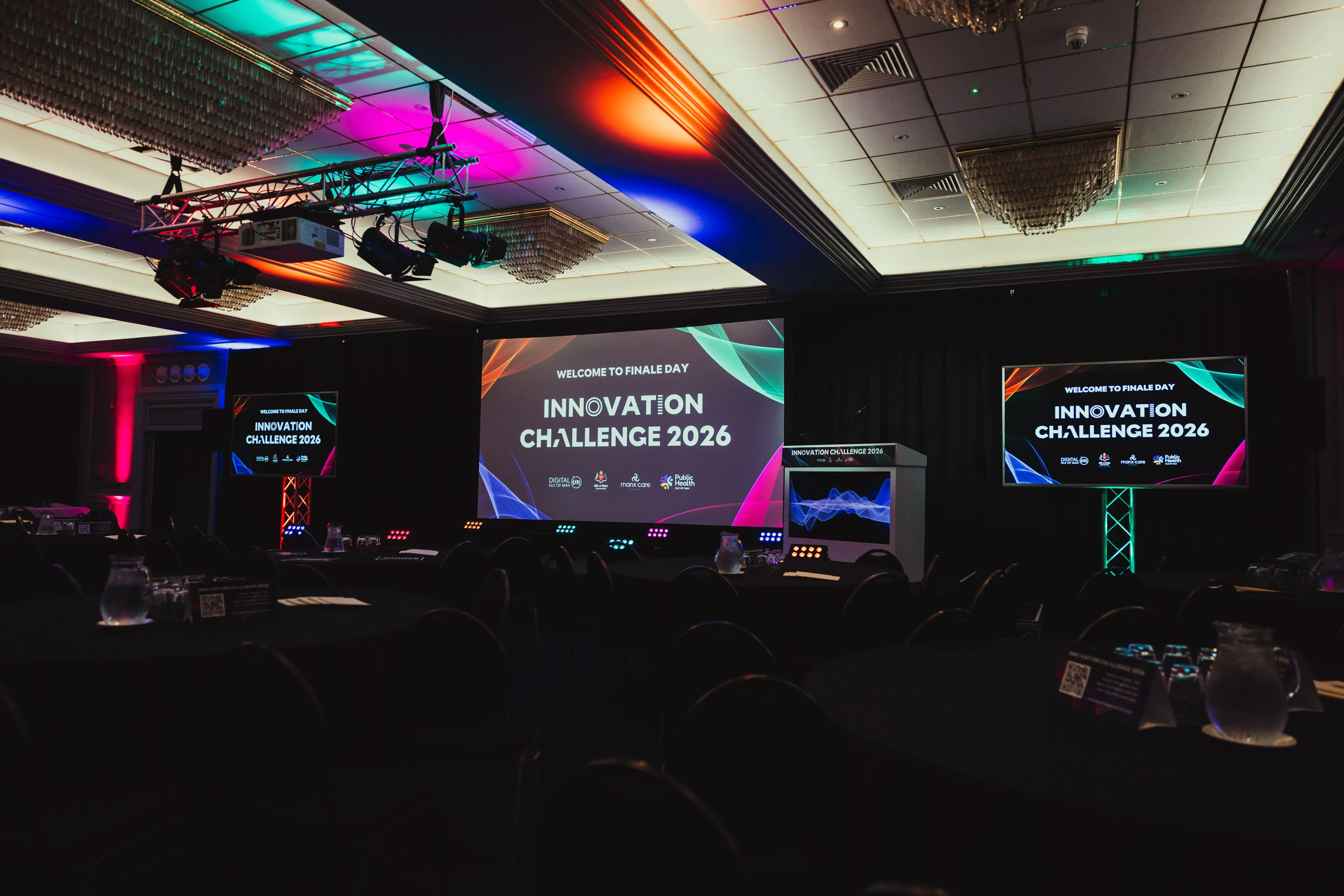 Wide shot of the empty finale day setup with "Welcome to Finale Day" screens displayed at the Comis Hotel