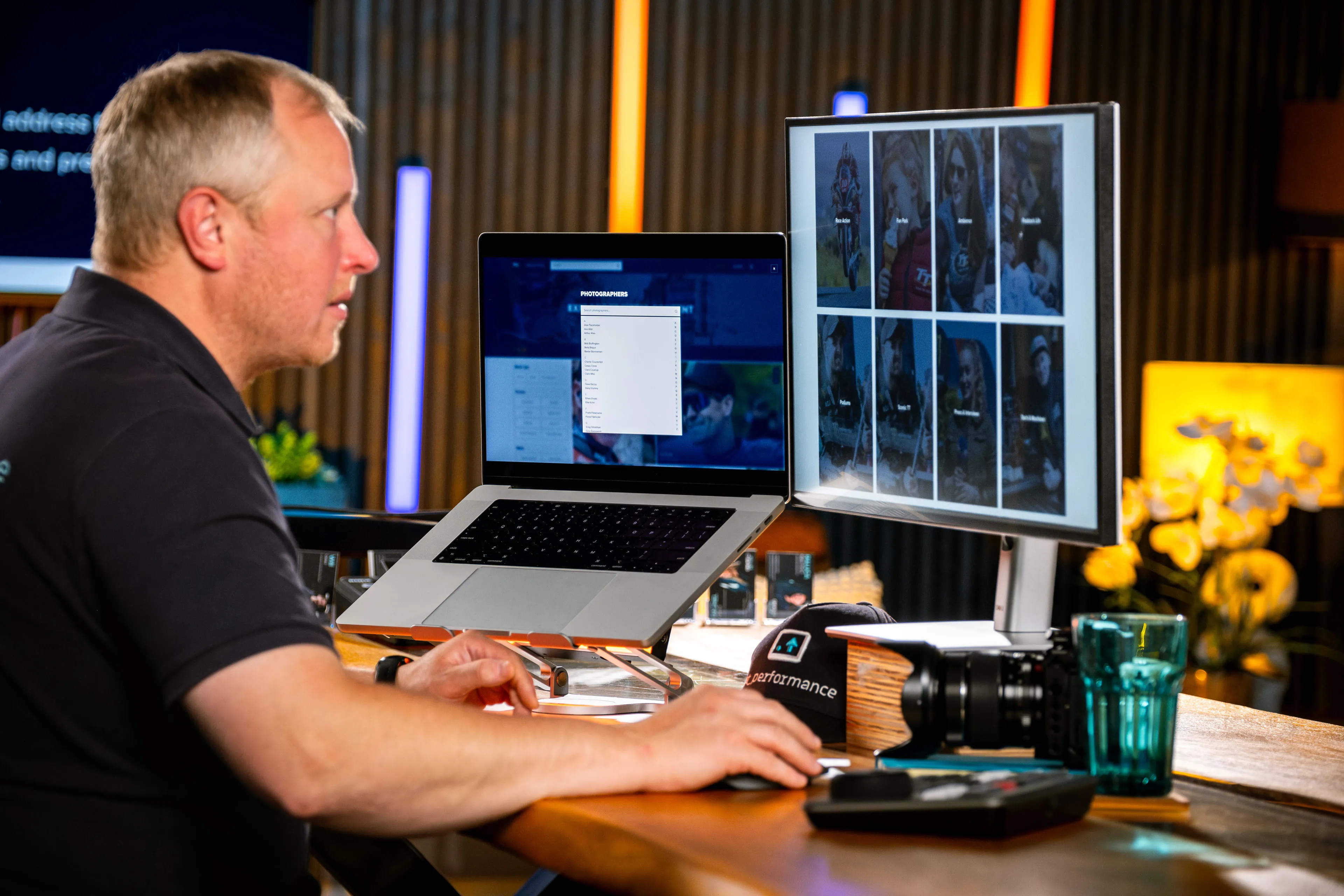 Juan Readshaw browsing different sections of the TT Media Portal across a MacBook and monitor at DotPerformance.