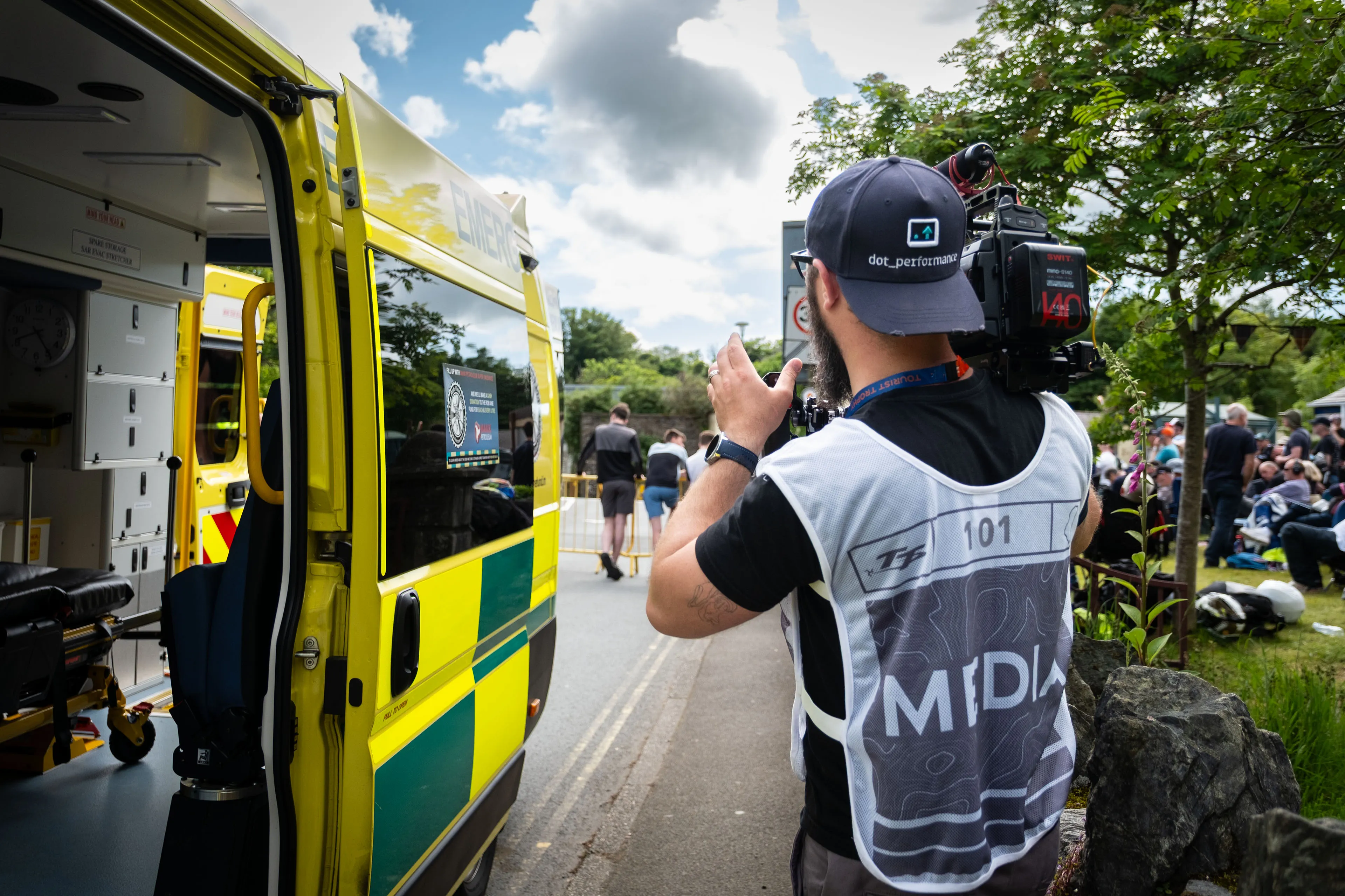 Nico van Loggerenberg filming details of a St John Ambulance vehicle at the roadside during the TT races