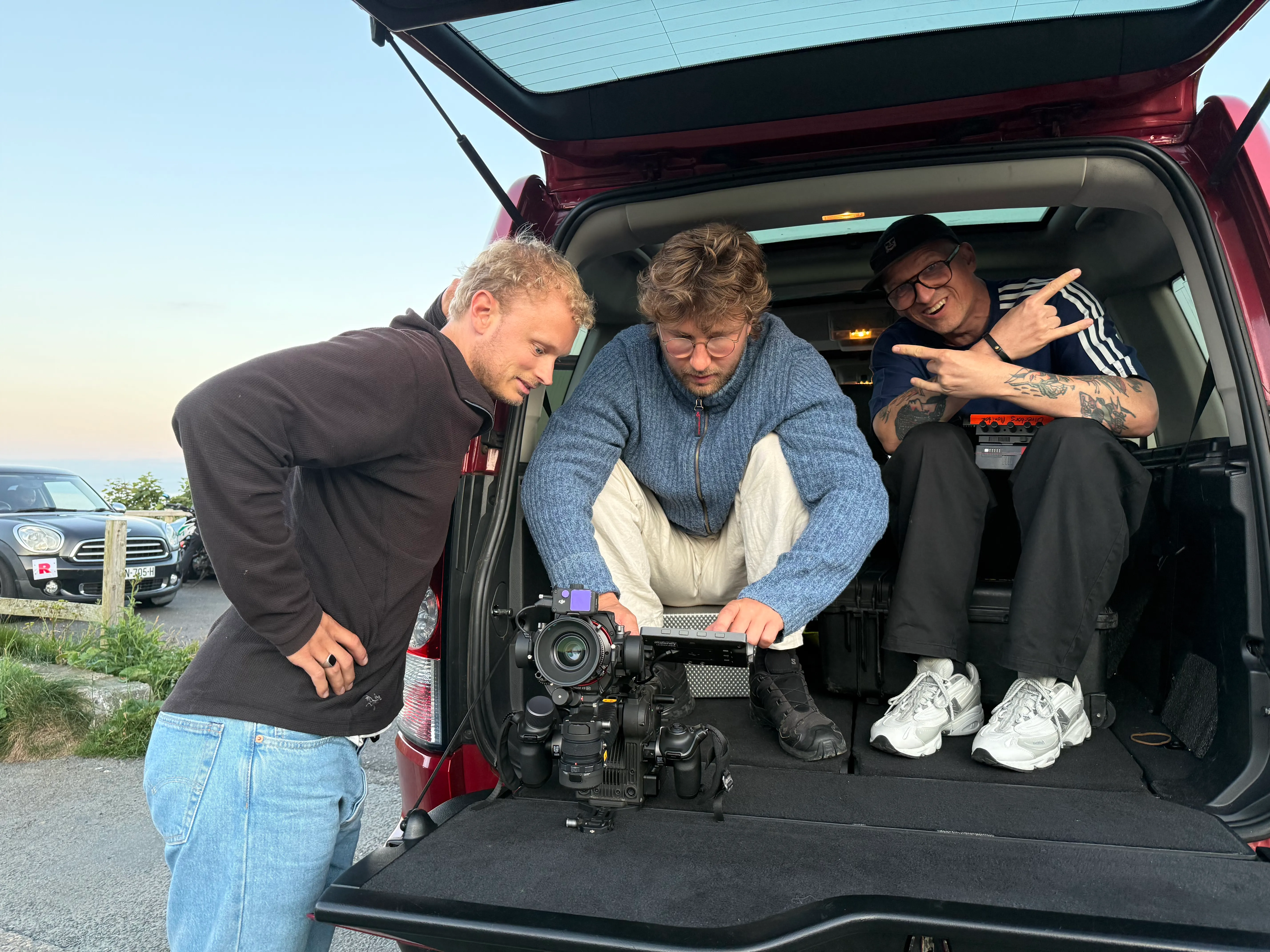 Joey, Zeeger and Ralf from Taya preparing a DJI Ronin 4D cinema camera in the boot of a vehicle on location on the Isle of Man during a vehicle-mounted shoot