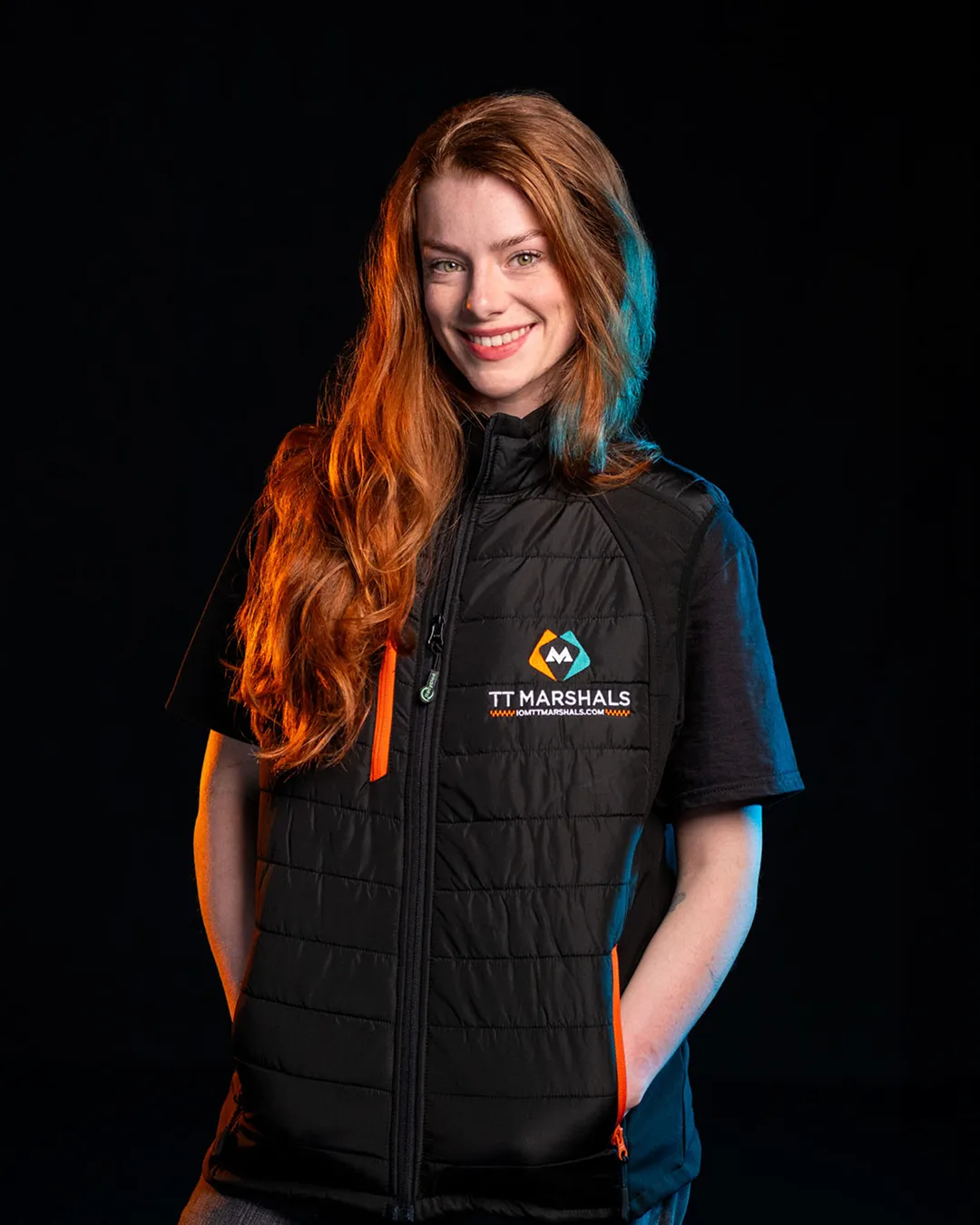 Ella Garvey wearing the official TT Marshals 2026 black padded gilet, featuring the TT Marshals logo. Exclusive marshal merchandise for the Isle of Man TT 2026.