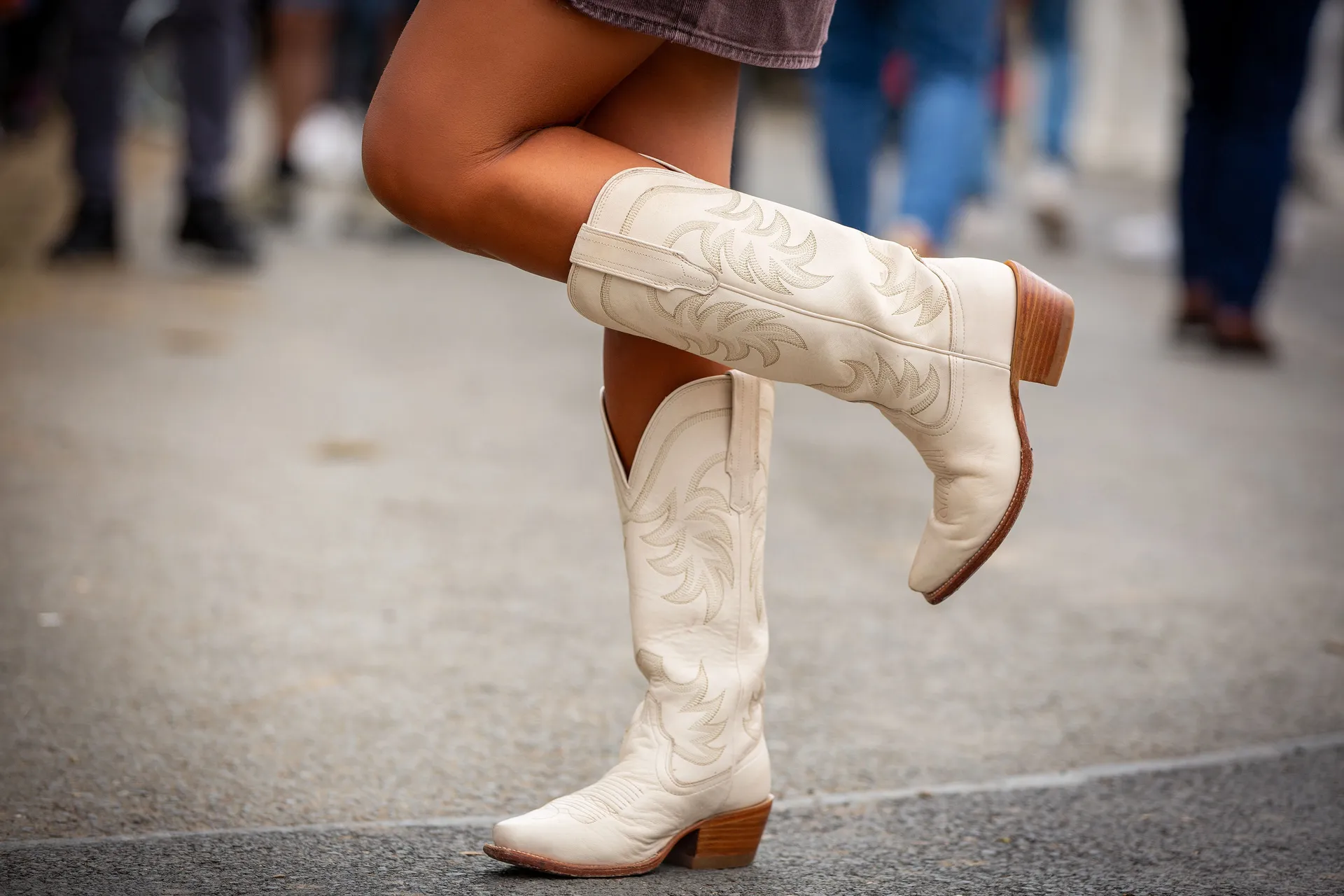 Close-up of a marshal’s white cowboy boots during the TT