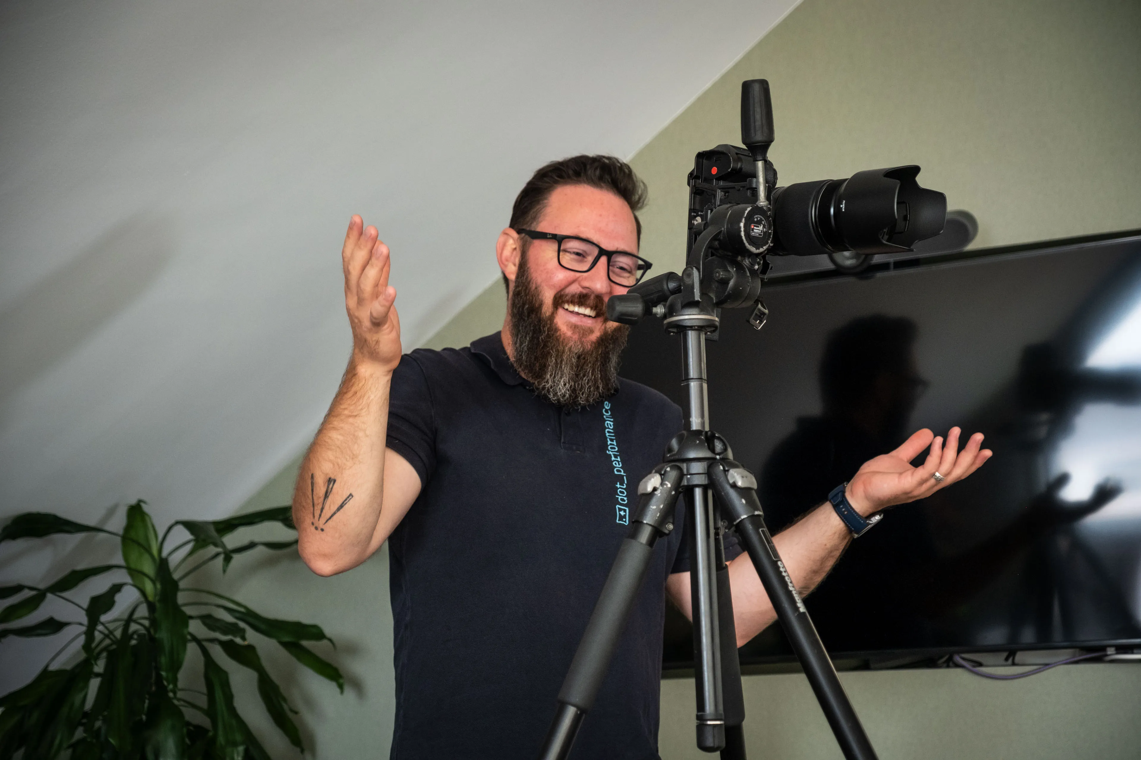 Nico van Loggerenberg shrugging his arms up in a comedic manner while talking to the subject he is photographing at Boal & Co.