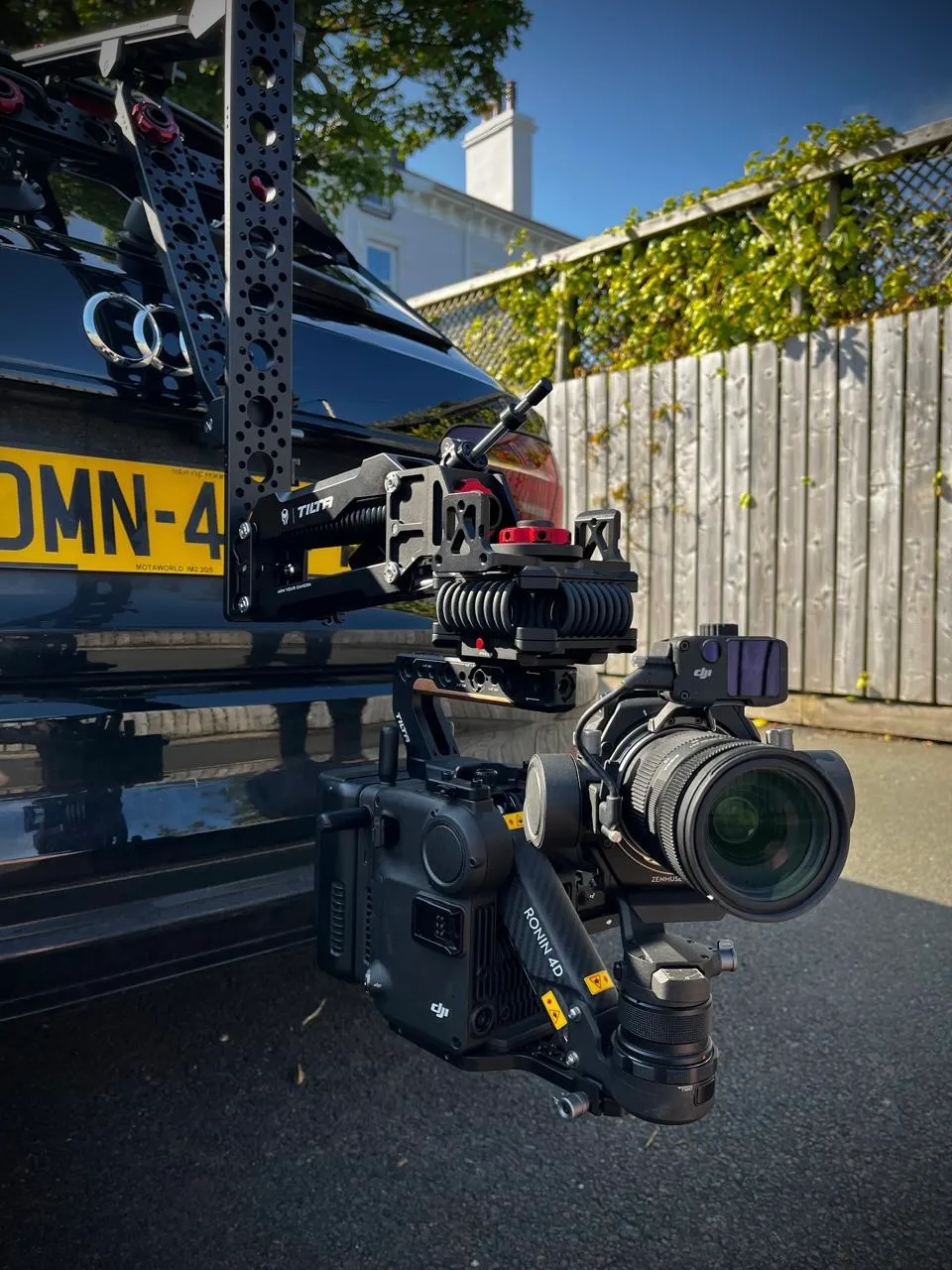 Close-up of a DJI Ronin 4D cinema camera mounted on a Tilta Hydra Alien arm attached to a vehicle during a DotPerformance production shoot on the Isle of Man