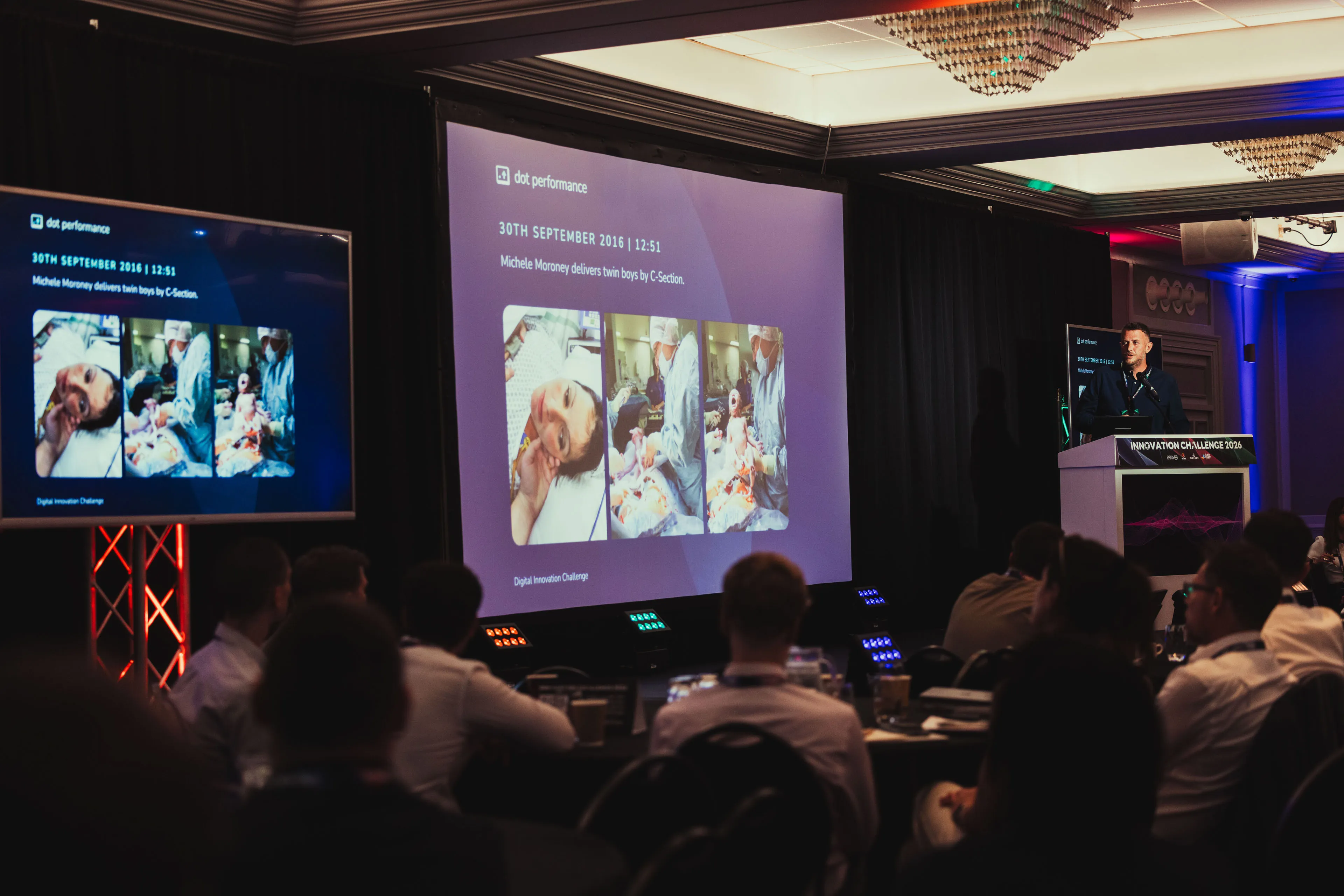 Andy Orton presenting beside twin screens showing Michele Moroney delivering twin boys by C-section on 30th September 2016