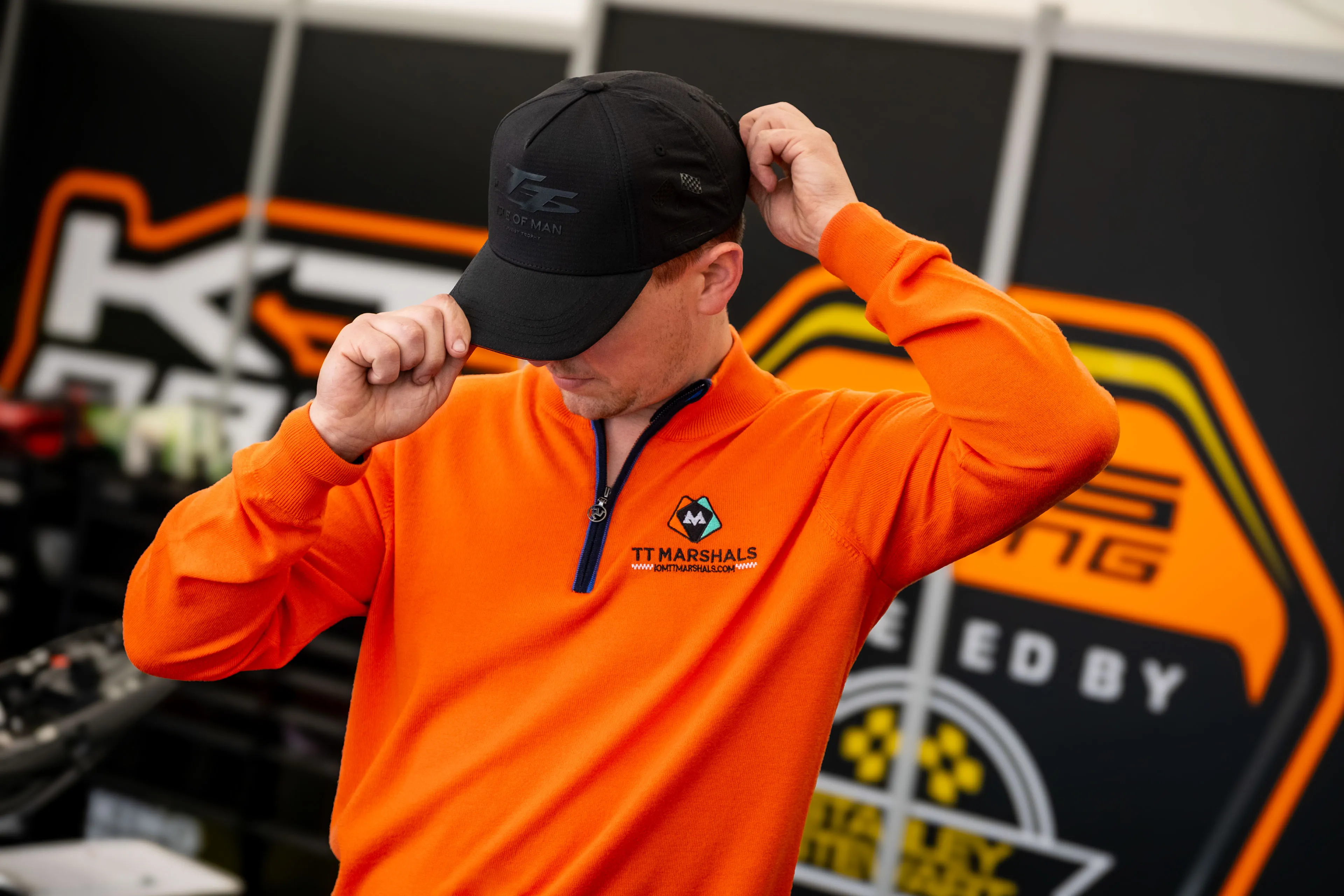 Dom Herbertson getting ready in his racing marquee wearing the TT Marshals Albion Knitware prize jumper