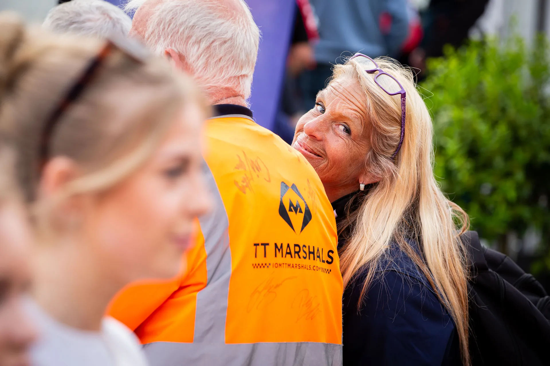 Two marshals, one in a TT Marshals orange top, during TT 2026