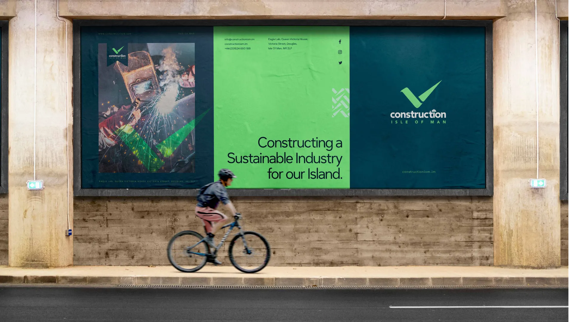 A Construction Isle of Man billboard mockup showing a welding photograph alongside the brand message "Constructing a Sustainable Industry for our Island" and the Construction Isle of Man logo designed by DotPerformance
