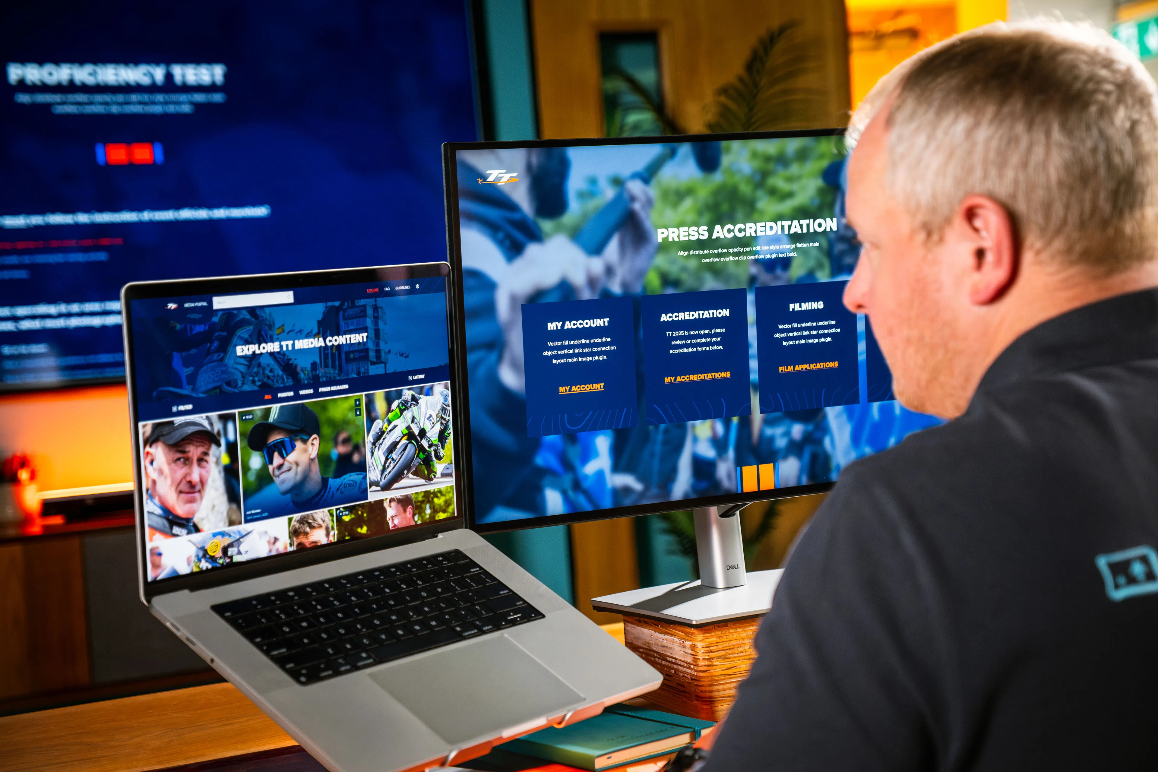 Over-the-shoulder view of Juan Readshaw browsing through the TT Media Portal, showing the Press Accreditation page