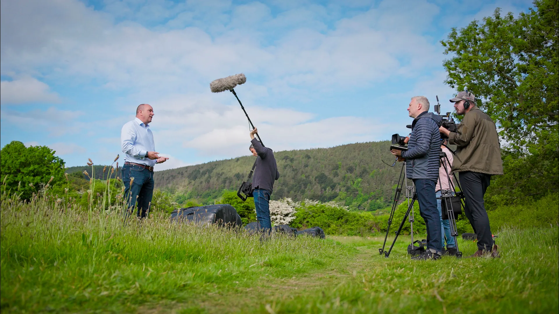 DotPerformance video production crew and Limehouse's crew filming a presenter on location in open hillside countryside during a brand film shoot