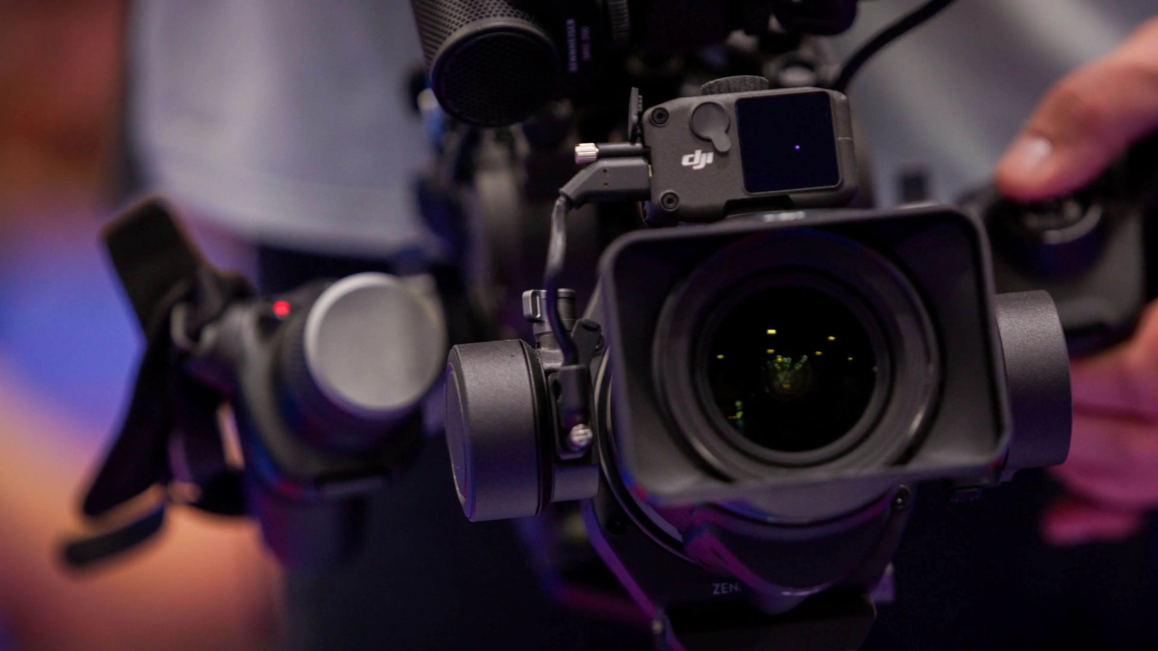 DJI Ronin 4D cinema camera held on set during a DotPerformance video production shoot, showing the integrated stabilisation system and lens detail