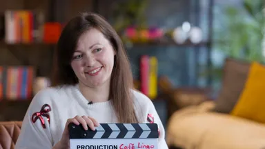 Oksana Fedorovych holding a Café Lingo clapperboard at DotPerformance studios during production of the Oksana's Story documentary, Isle of Man