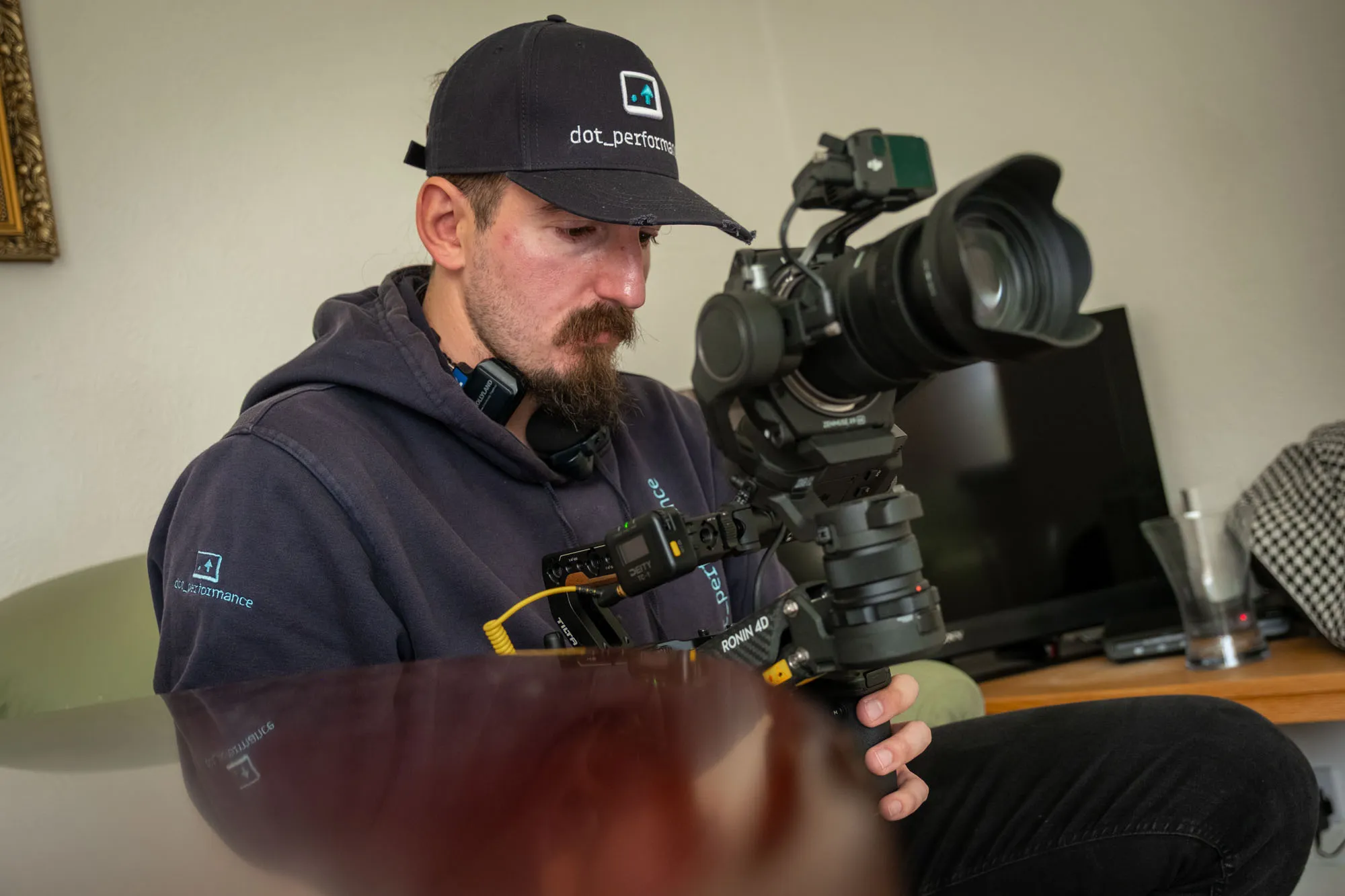 Will Oates, DotPerformance video production crew member, preparing a DJI Ronin 4D cinema camera on location during a shoot on the Isle of Man