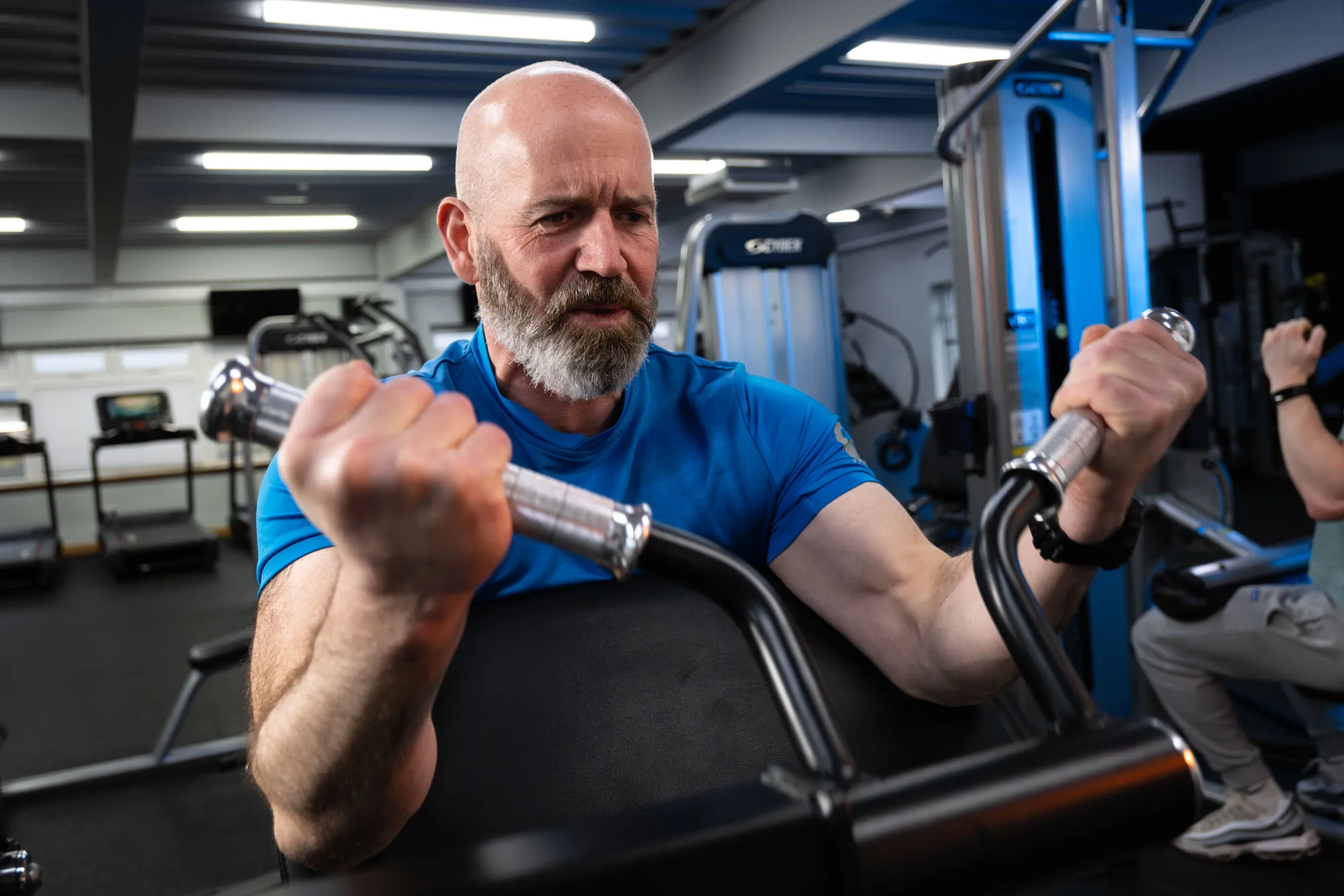A member using a weights machine at West Coast Fitness on the Isle of Man, photographed for DotPerformance