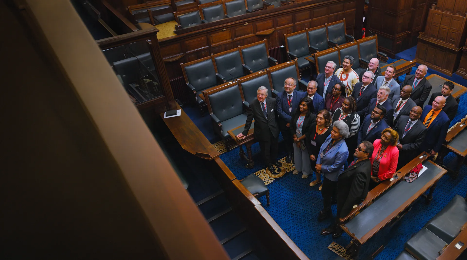 Delegates gathered in a parliamentary chamber, looking up