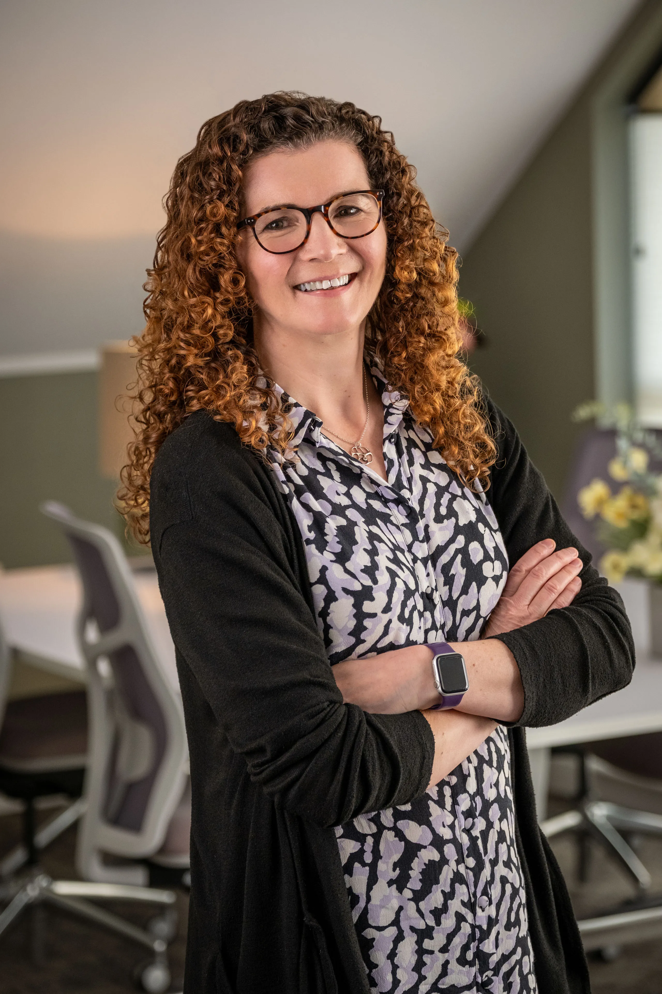Professional headshot of Ruth Cannell, wearing glasses and a black cardigan over a patterned blouse, taken during the Boal & Co 2026 portrait session.