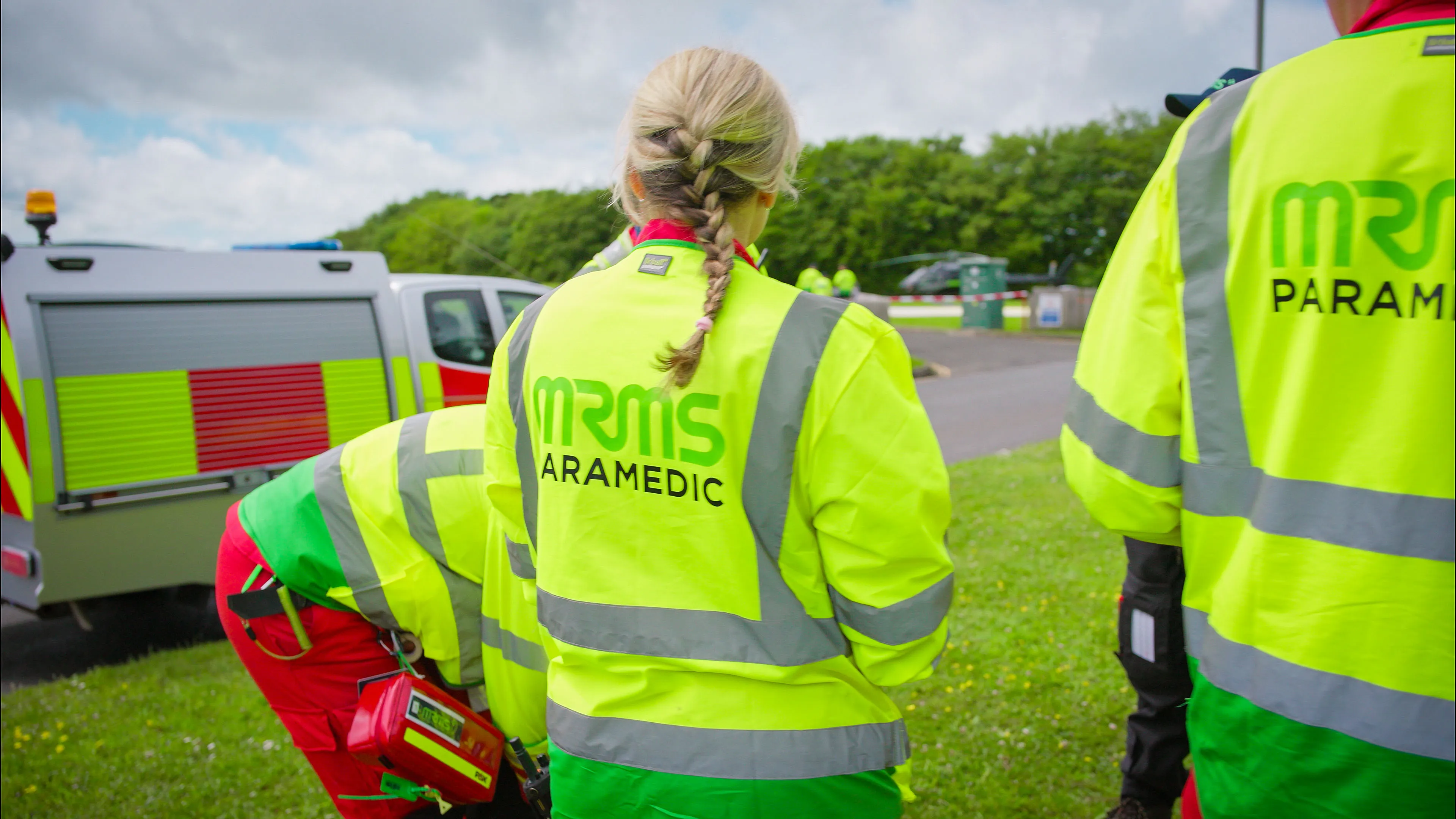 MRMS paramedic discussing plans and packing gear beside the fire truck ahead of deployment