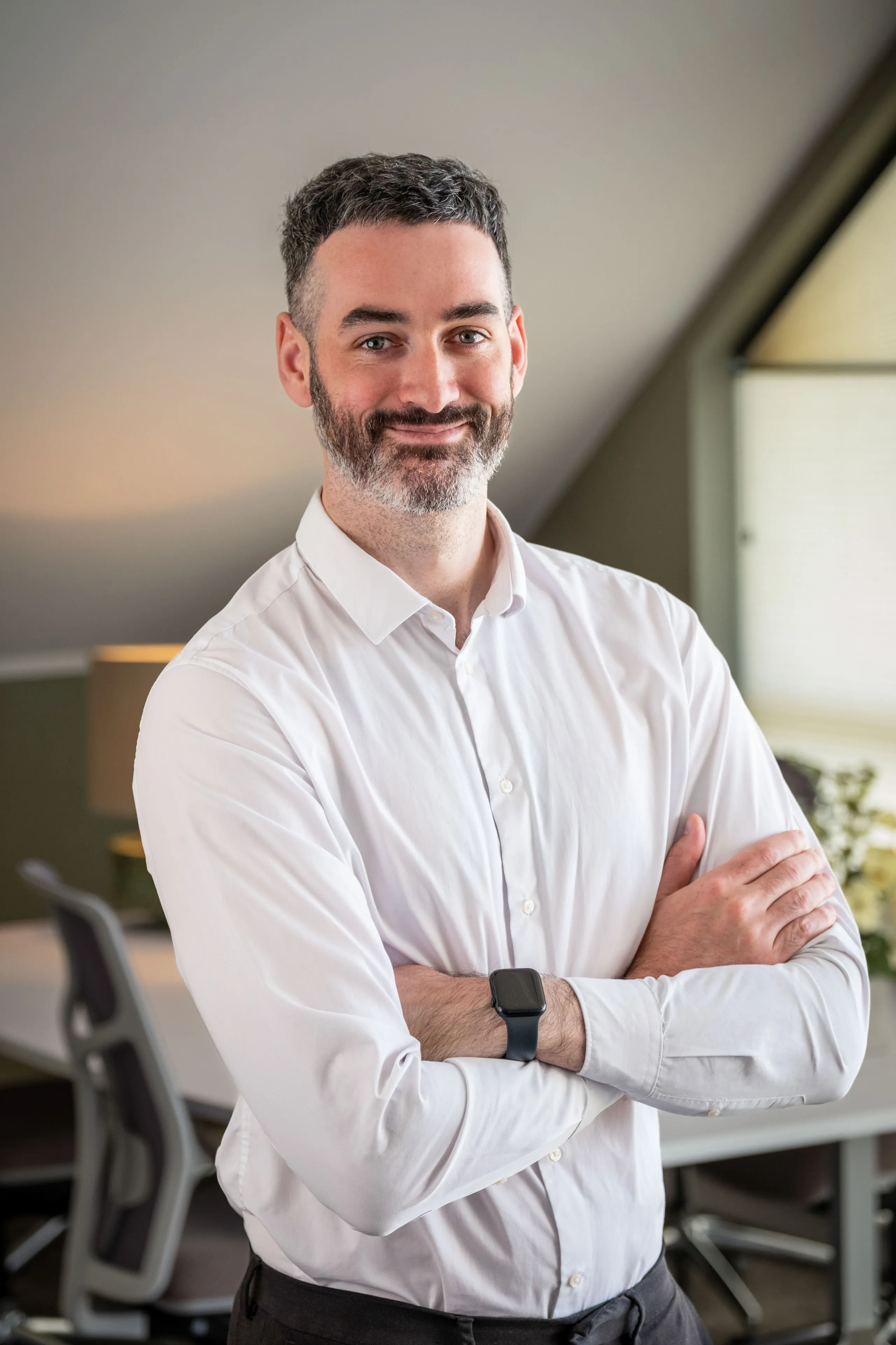 Professional headshot of Dean Kearns, arms crossed and smiling in a white shirt, taken during the Boal & Co 2026 portrait session.