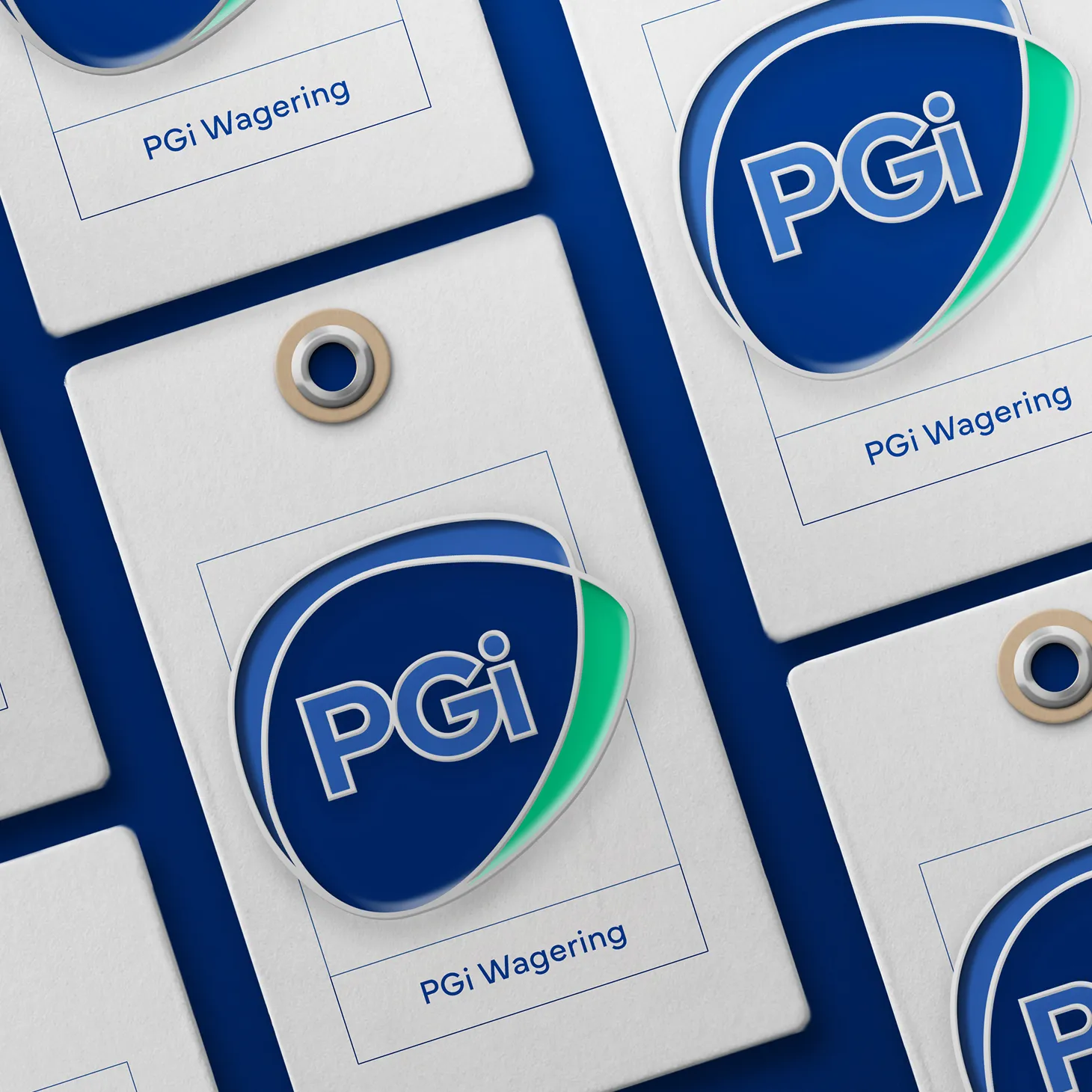 PGi Wagering branded swing tags and badge mockups showing the logo designed by DotPerformance, laid out on a navy blue surface