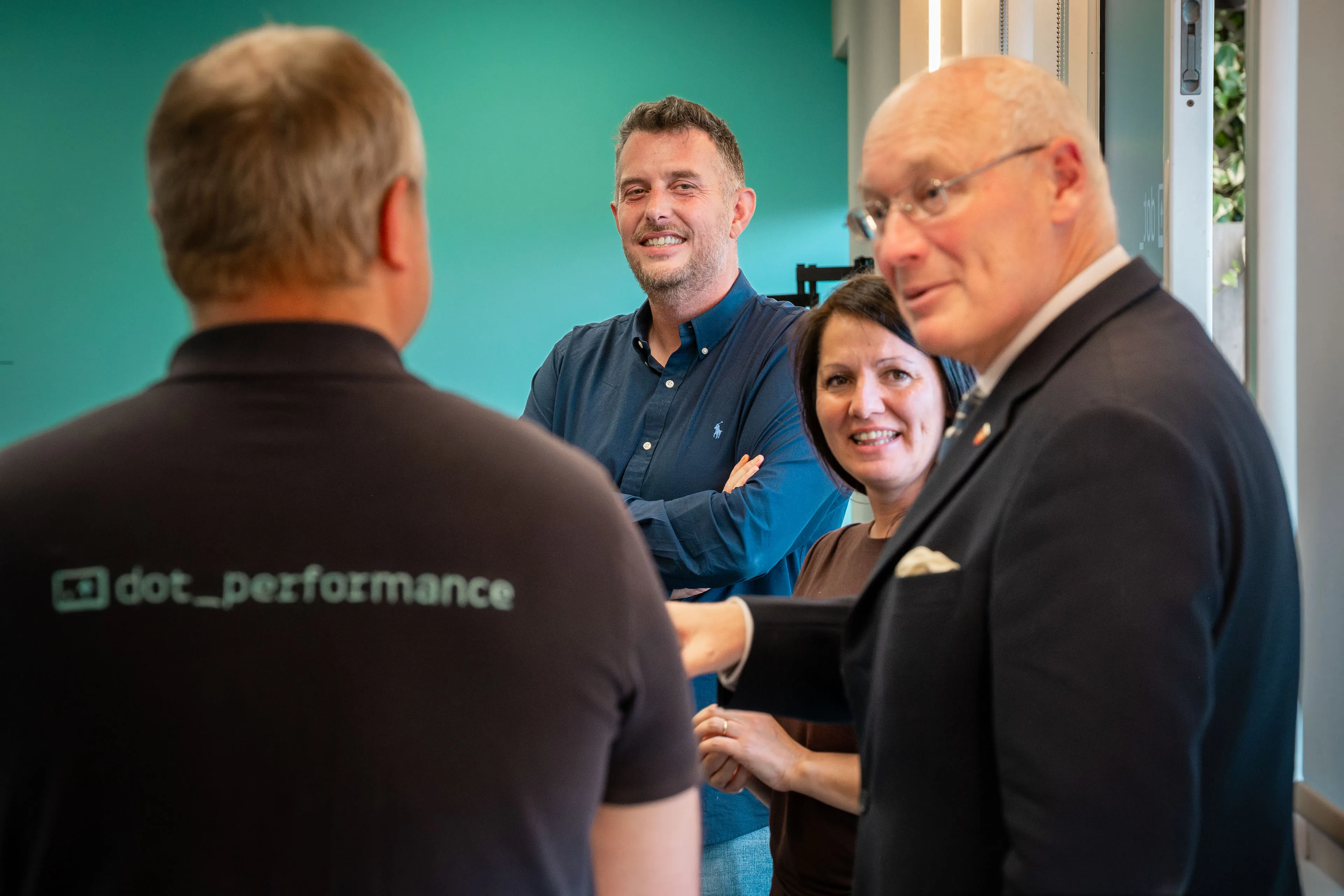 Andy Orton smiling as Lieutenant General Sir John Lorimer KCB DSO MBE tells the team a story