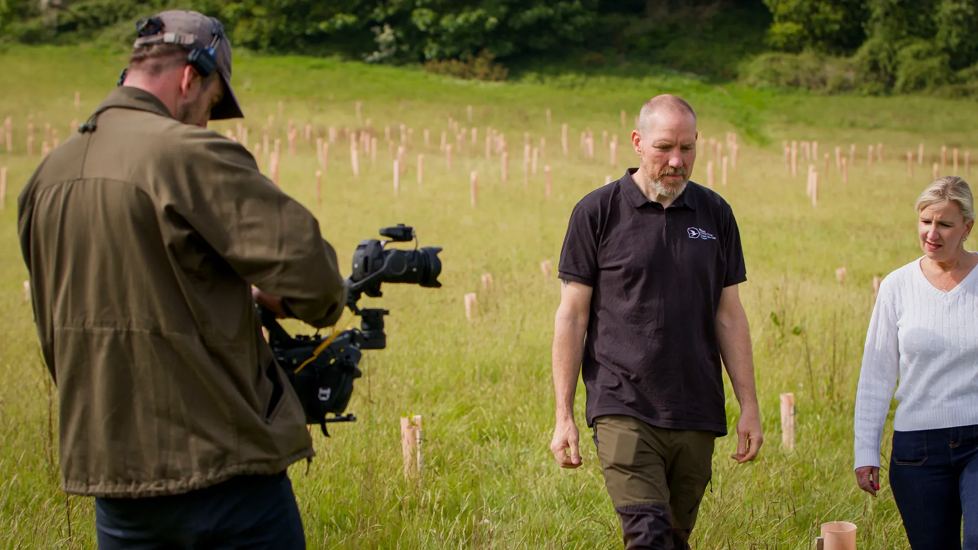 Will Oates using a DJI Ronin 4D to film a walk-and-talk sequence in an outdoor field location on the Isle of Man