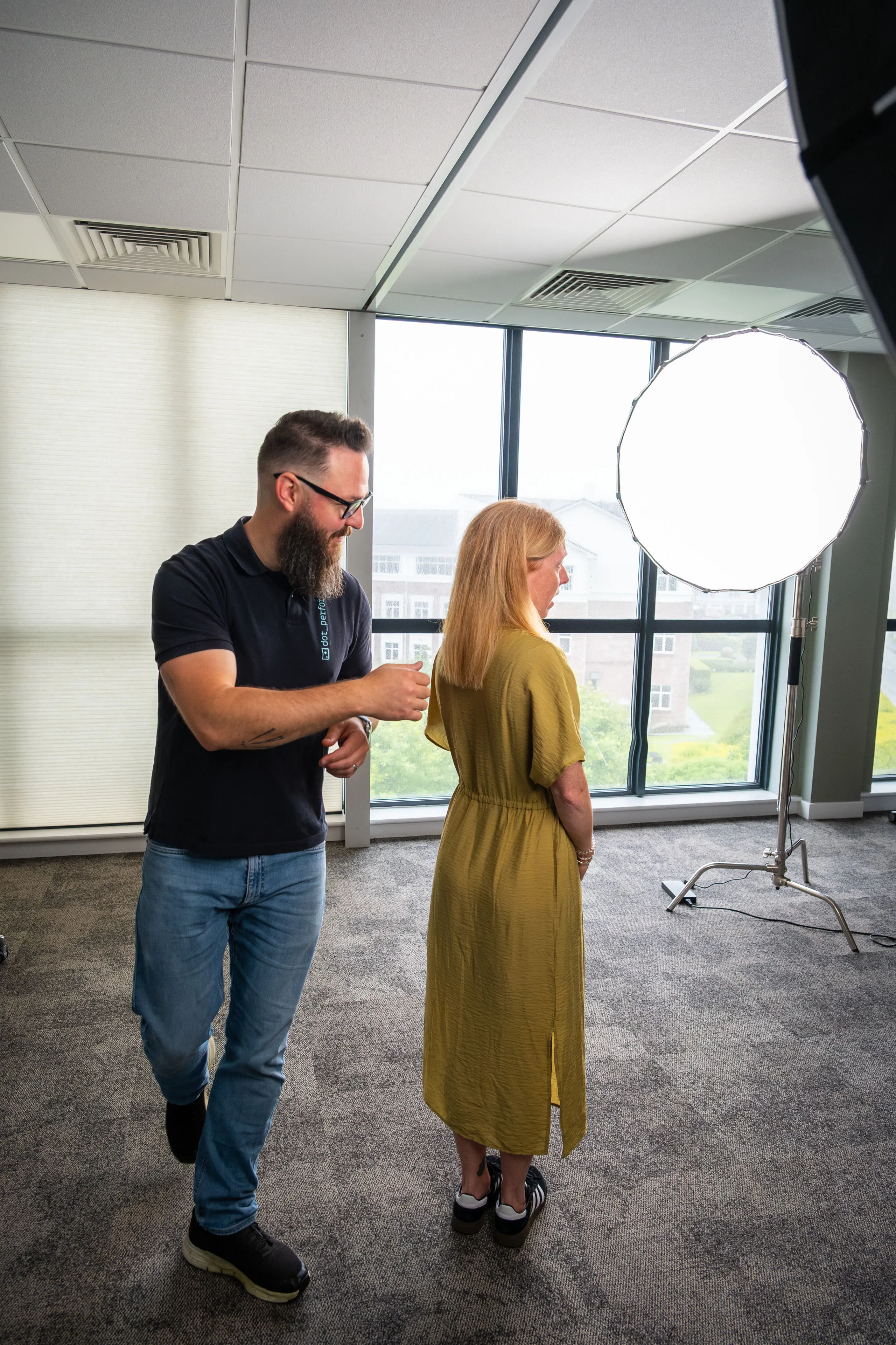 Nico van Loggerenberg adjusting the hair of Natalie Casement before her portrait session at Boal & Co's offices.