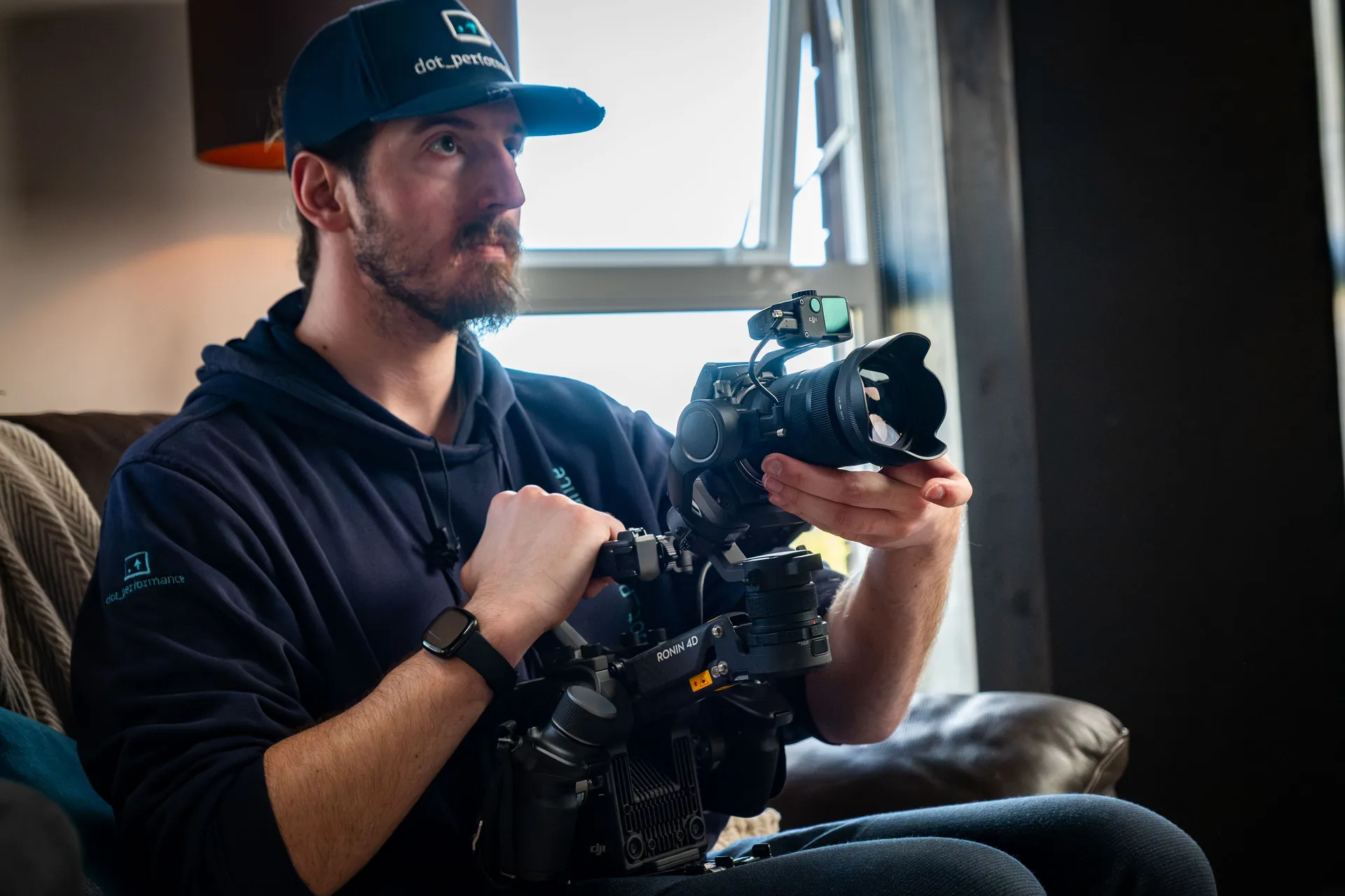 Will Oates wearing a DotPerformance cap handling a DJI Ronin 4D camera during a video production at DotPerformance studios on the Isle of Man