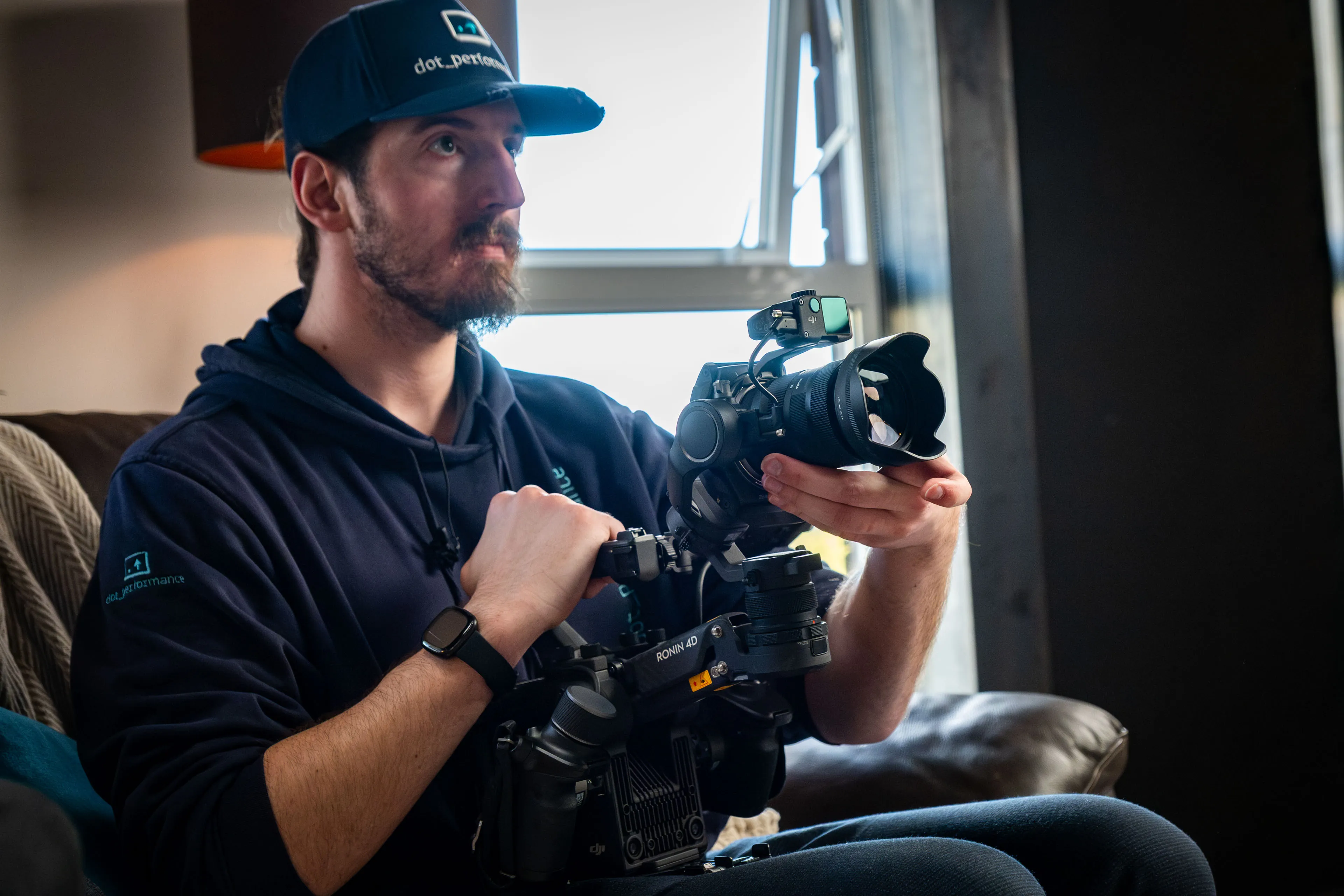 Will Oates wearing a DotPerformance cap handling a DJI Ronin 4D camera during a video production at DotPerformance studios on the Isle of Man