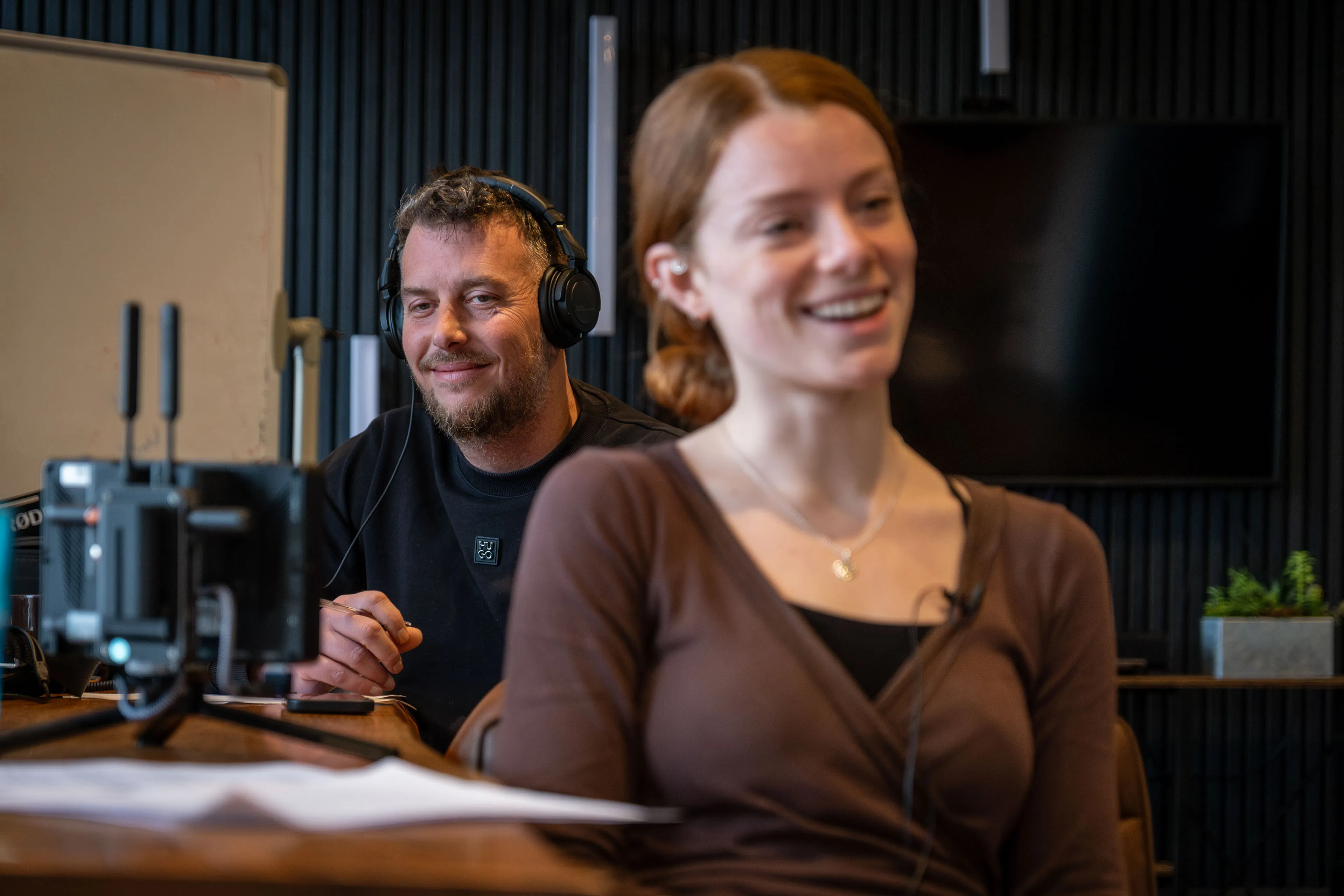 Andy Orton monitoring audio with headphones alongside Ella Garvey during documentary production at DotPerformance studios, Isle of Man