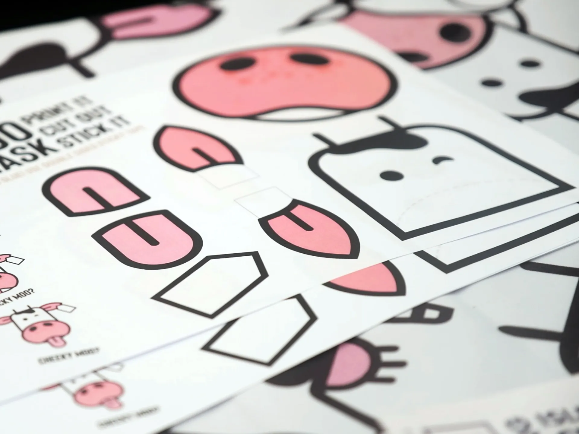 Printed Isle of Moo craft activity sheets designed by DotPerformance for the Isle of Man Creamery, showing cut-out cow character pieces for children