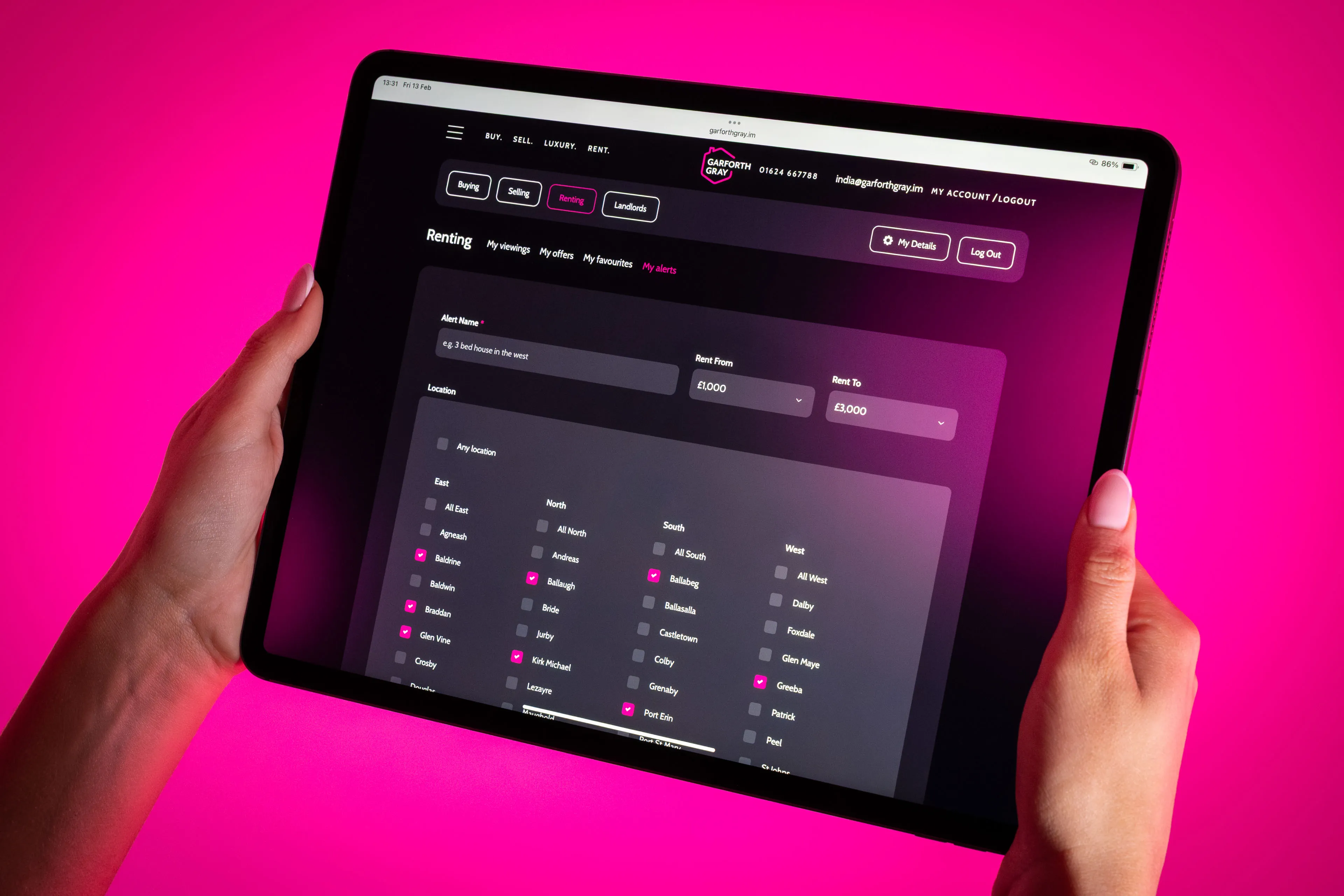 Hands hold a tablet showing a rental listing interface with a dark theme. The background glows pink, highlighting form fields and navigation.