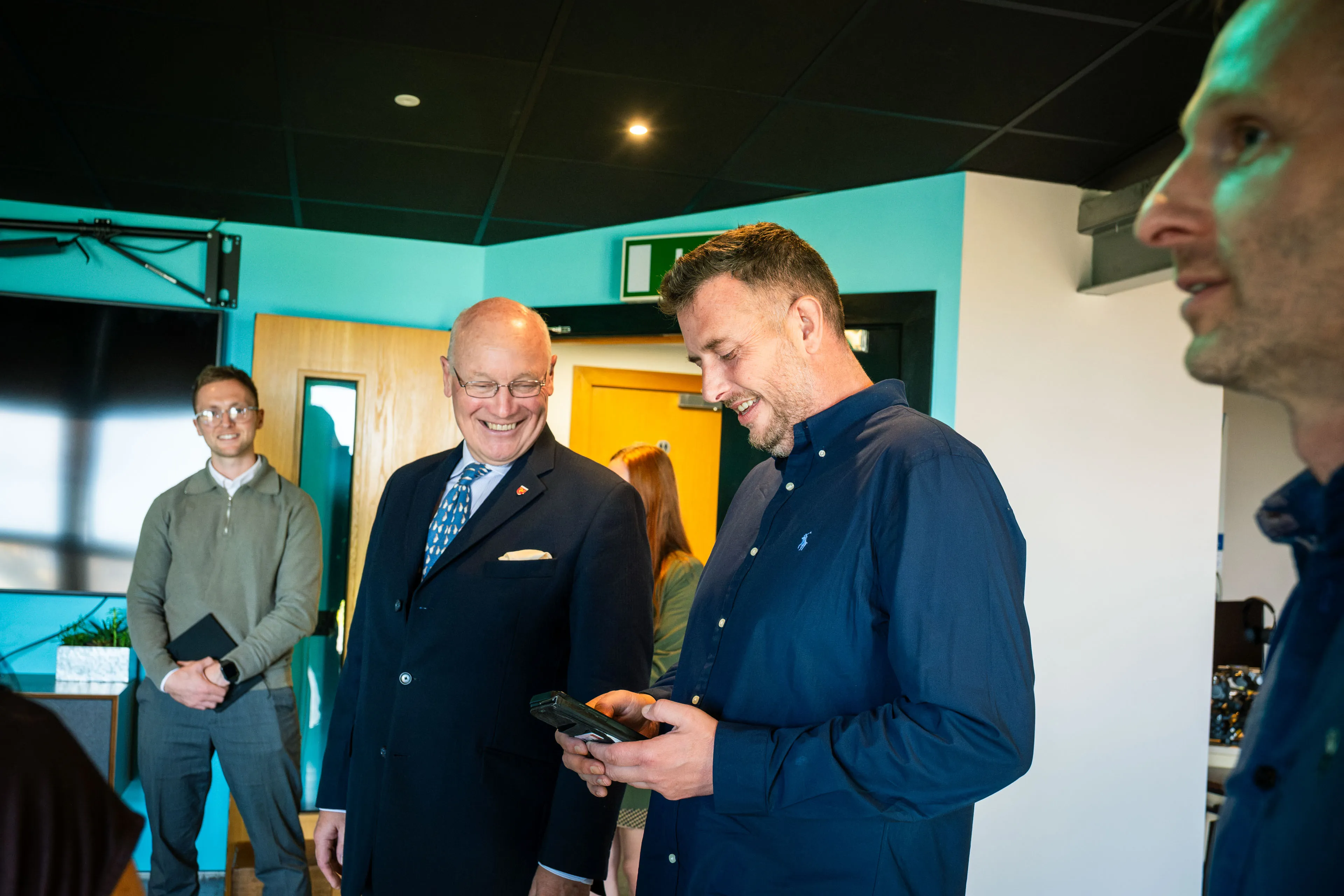 Andy Orton showing a smiling Lieutenant General Sir John Lorimer KCB DSO MBE how the studio lighting controls work
