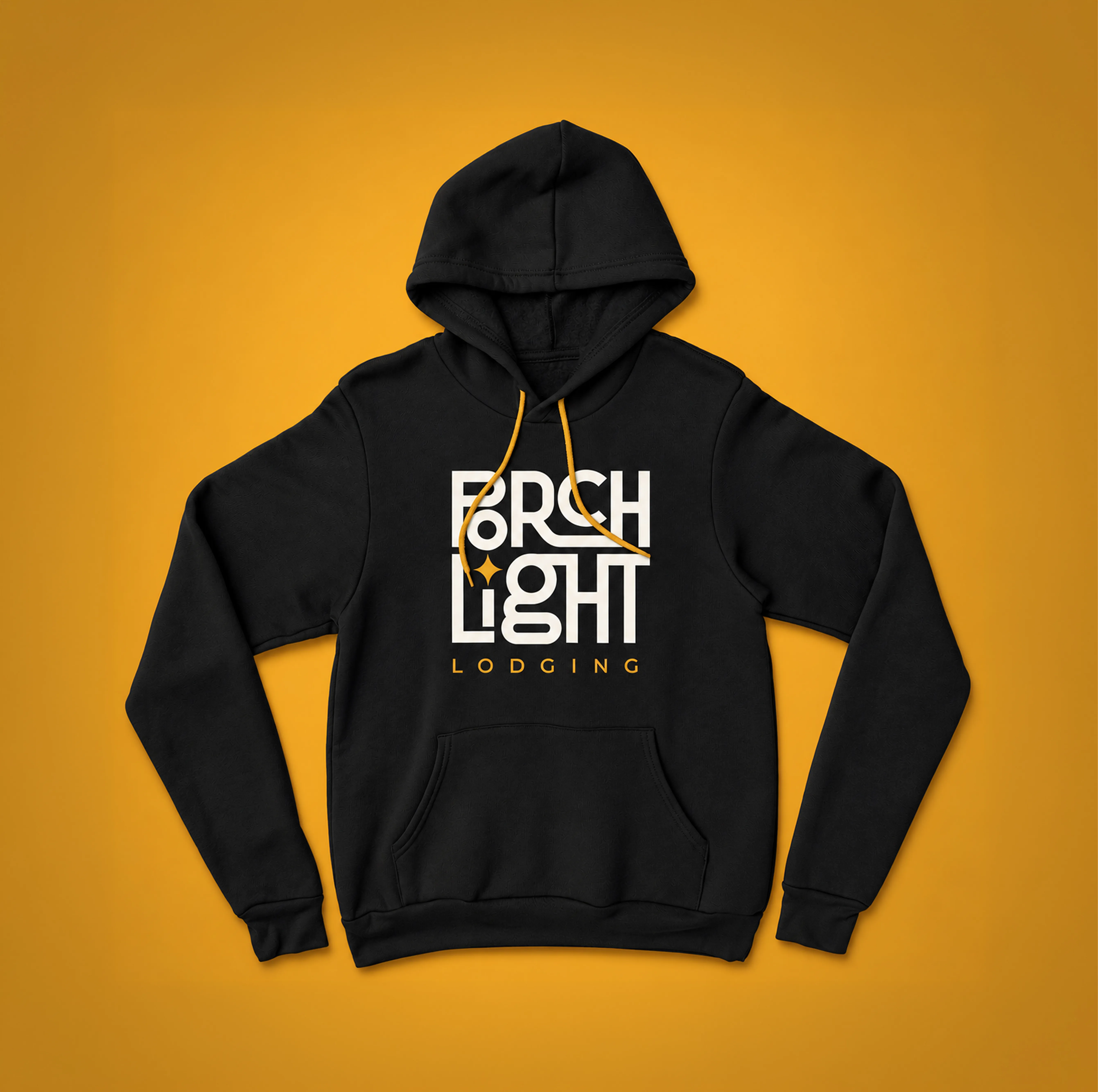 Black PorchLight Lodging hoodie with a cream logo, gold lettering and gold drawstrings, on a gold background