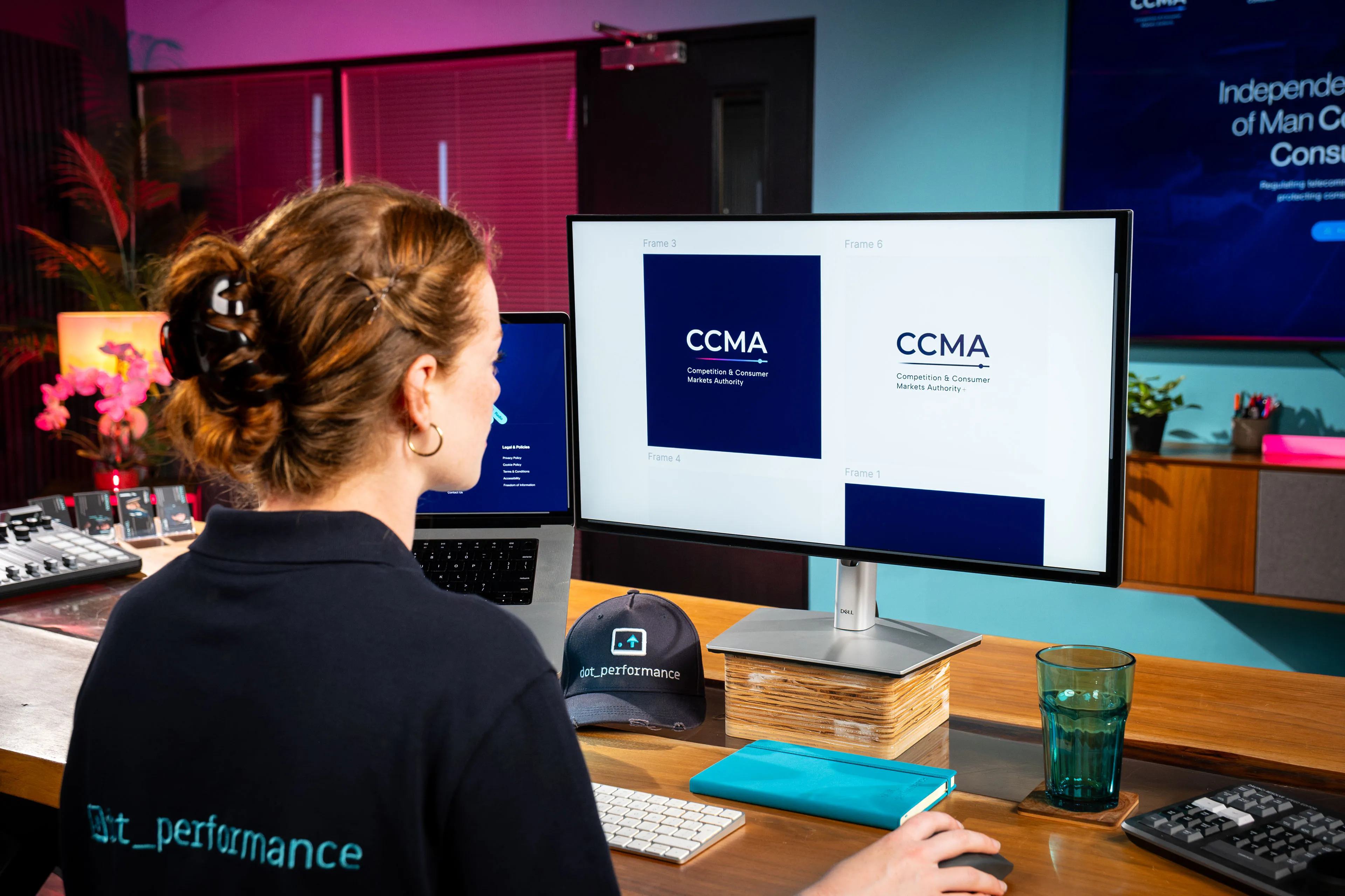 Ella Garvey comparing CCMA logo design options on screen while working on the CCMA website at DotPerformance