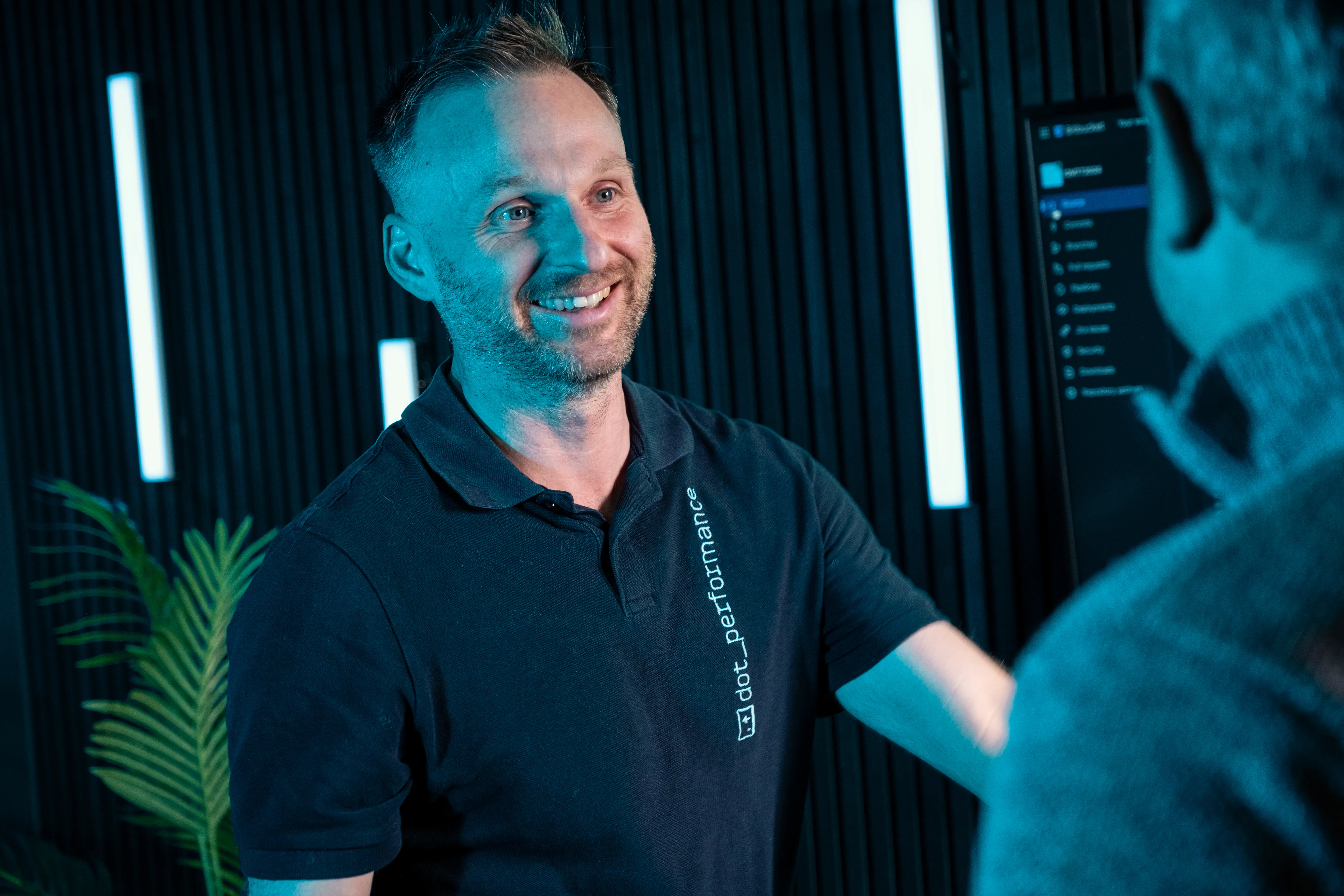 John, head of systems at dot performance, in studio, smiling at Juan.