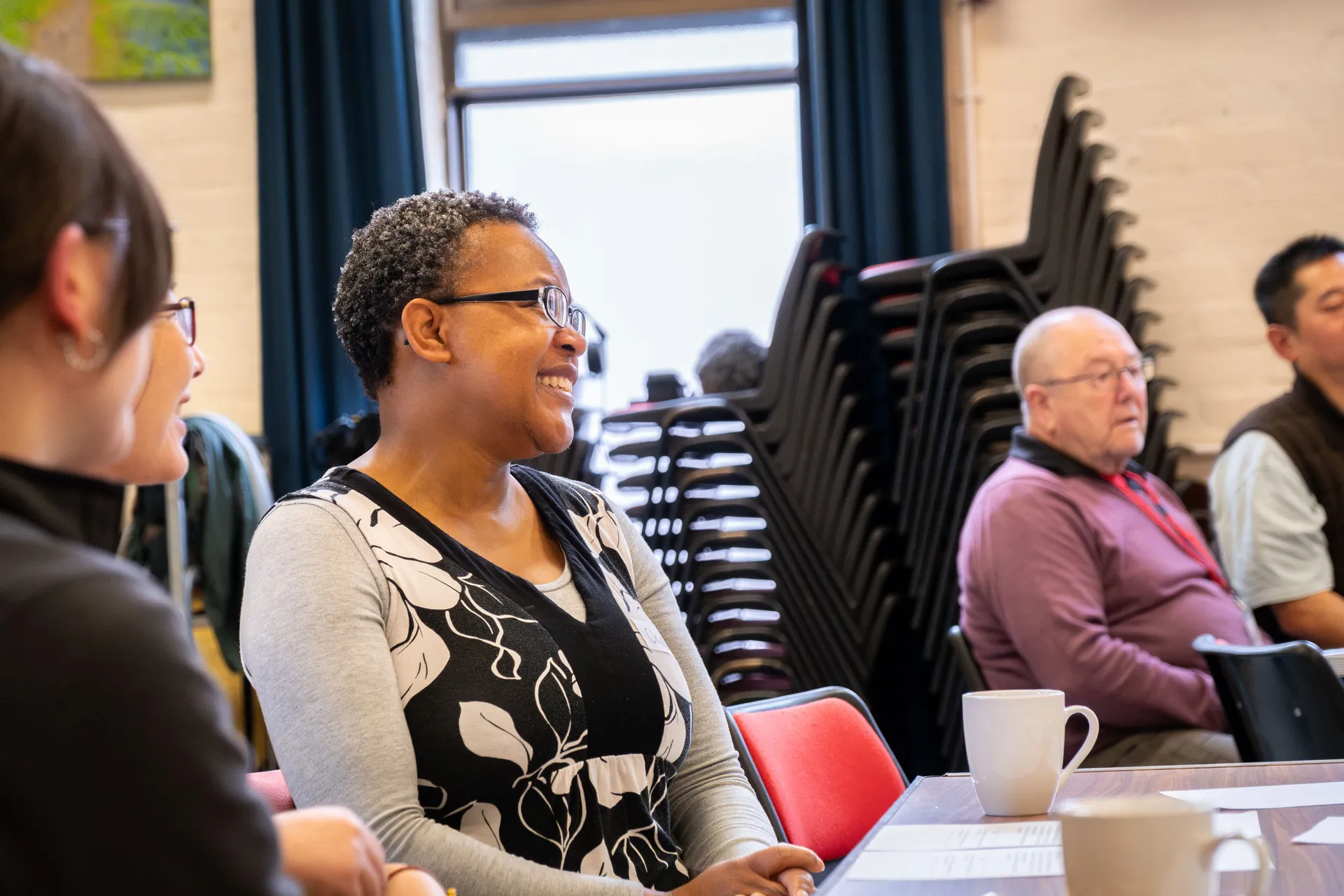 Café Lingo and Welcome Project participants talking during a community session filmed by DotPerformance at Douglas Promenade Church, Isle of Man