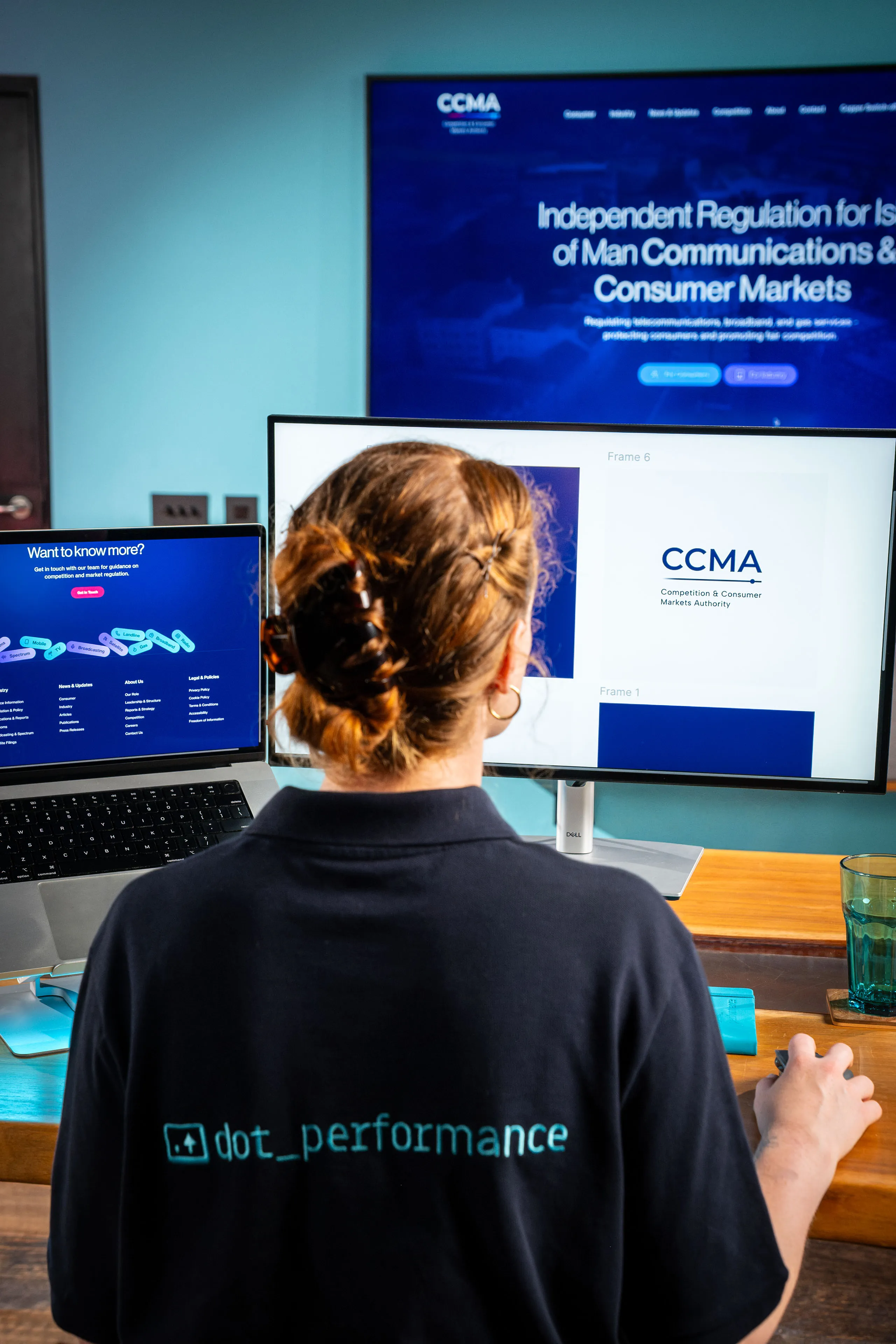 Ella Garvey working through the CCMA website homepage design on dual monitors at DotPerformance