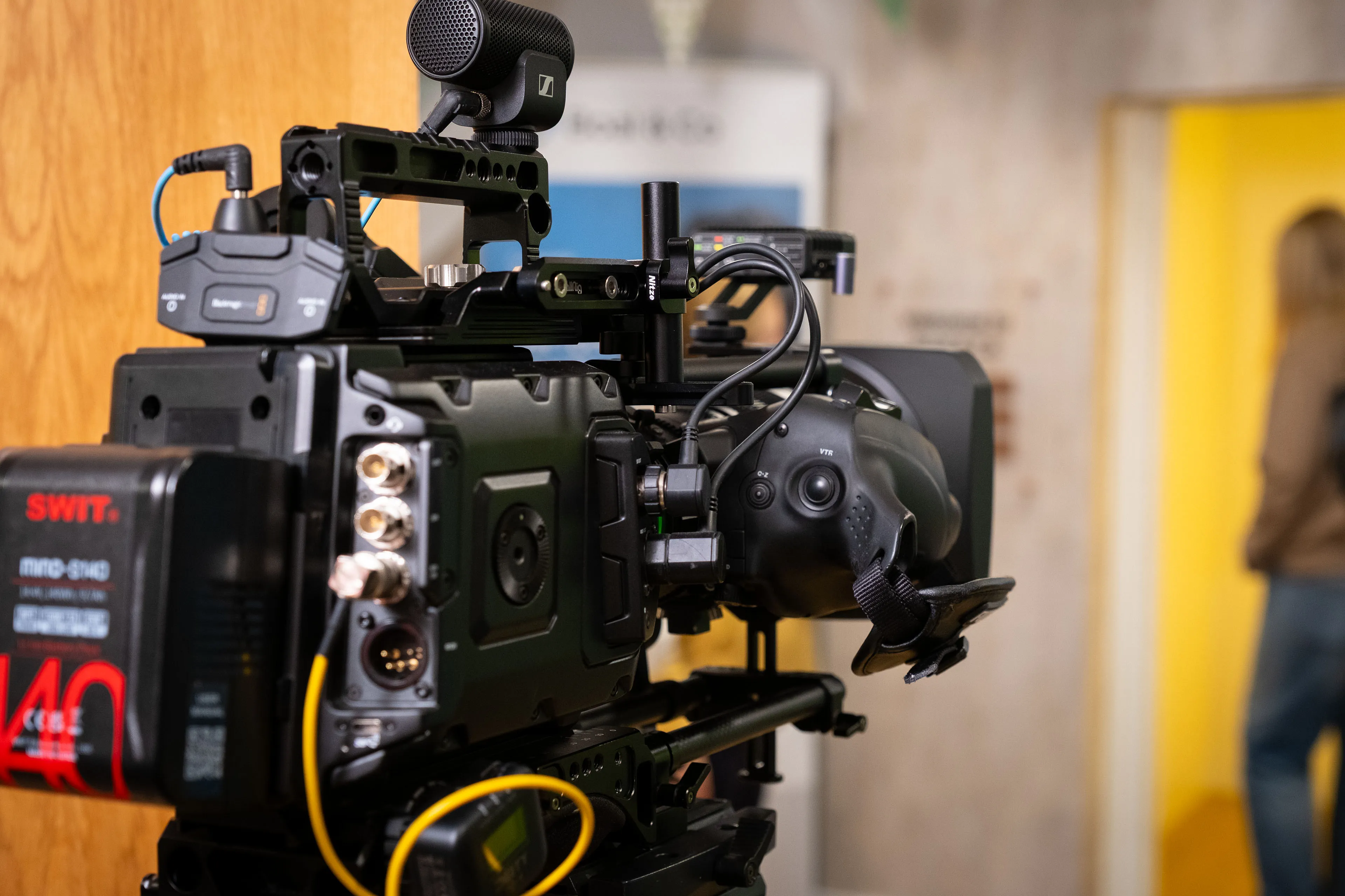 Blackmagic URSA 12K Mini Pro cinema camera on a tripod with a Deity timecode, set up on location at Boal & Co for the DotPerformance video production.