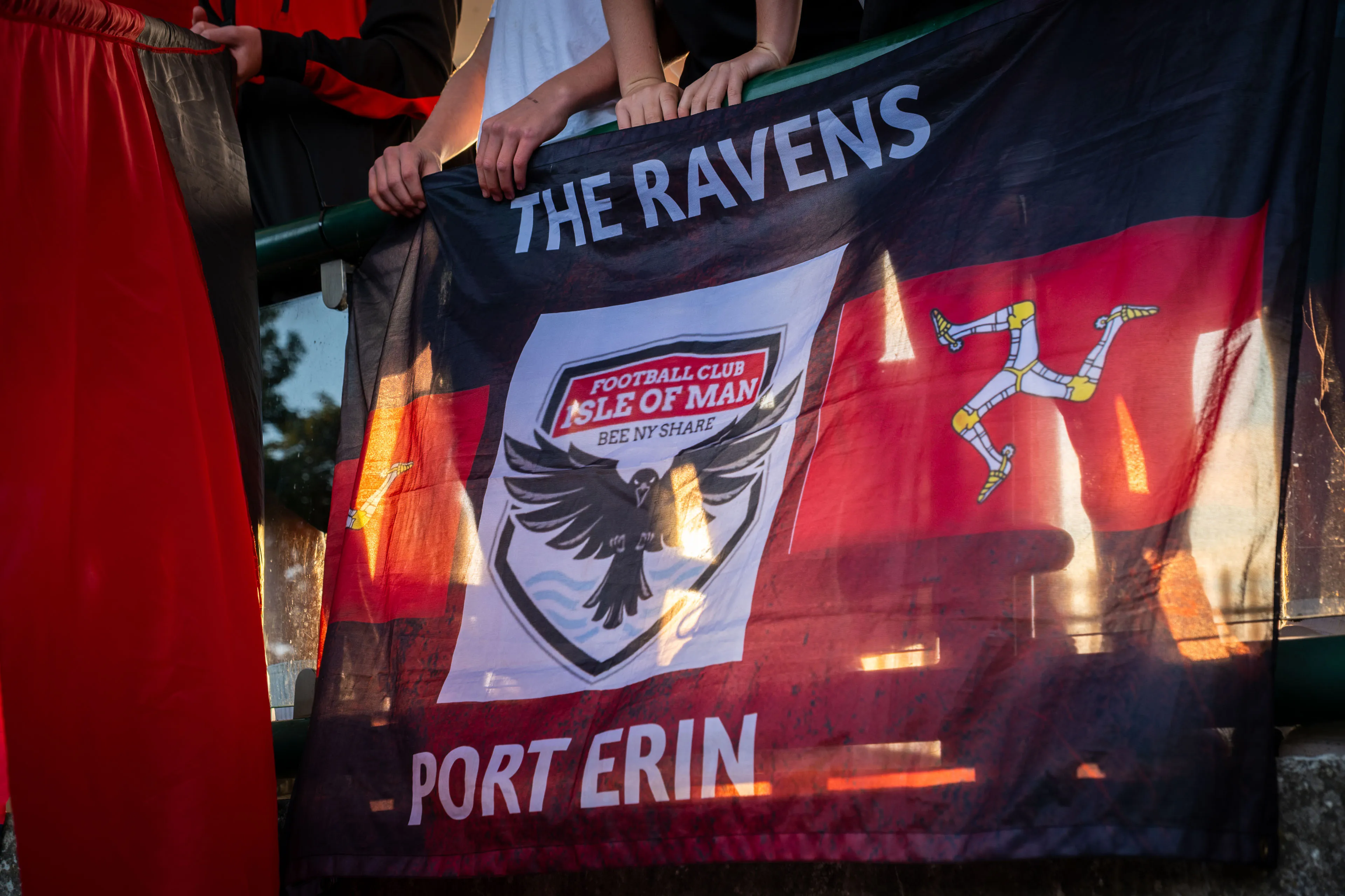 "The Ravens" FCIOM flag hung on the stands by fans at an FCIOM match