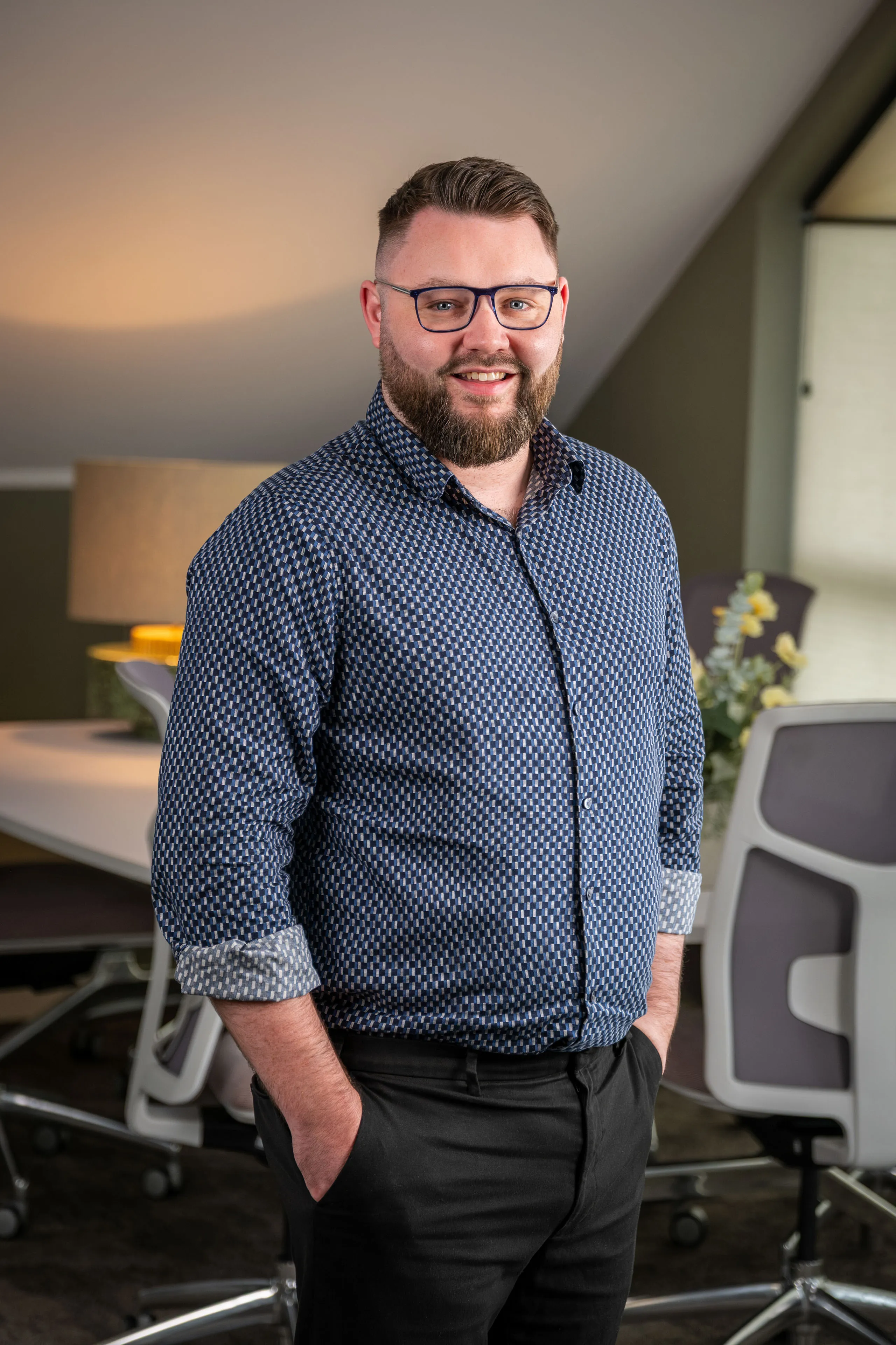 Professional headshot of Jordan Adams, arms crossed and smiling in a white shirt, taken during the Boal & Co 2026 portrait session.