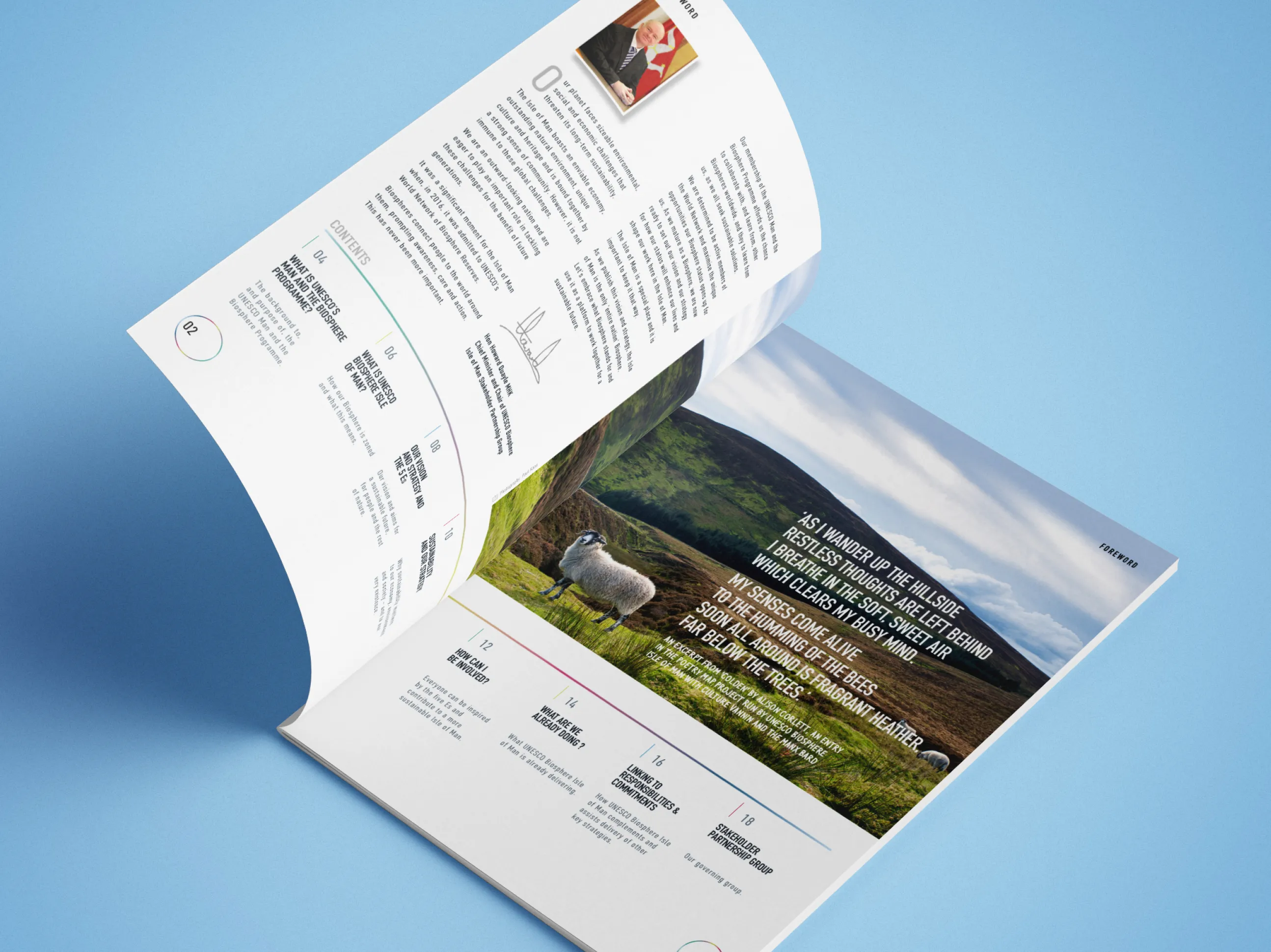 Biosphere Isle of Man Vision and Strategy printed booklet open at a spread showing an Isle of Man hillside landscape with a sheep and a poetry extract, alongside a colour-coded contents section, designed by DotPerformance