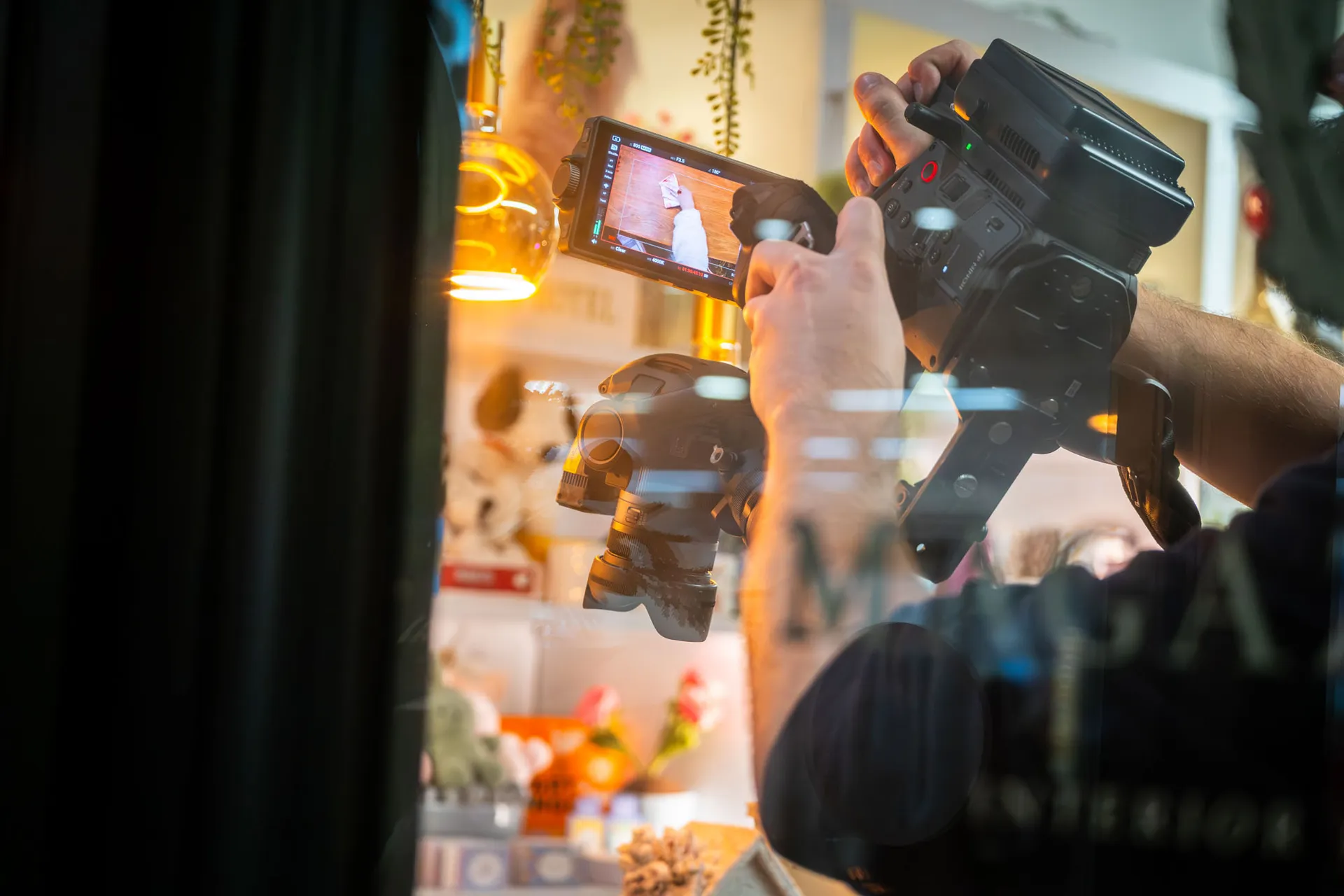 Will Oates operating a DJI Ronin 4D camera inside Magazzino Strand Street, Douglas, Isle of Man, during filming of the Business Isle of Man Buy Local campaign by DotPerformance
