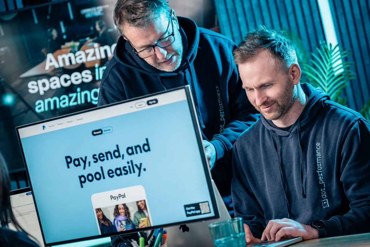 Simon King and John Beaty, DotPerformance team members, reviewing a website design on screen at the DotPerformance studio on the Isle of Man