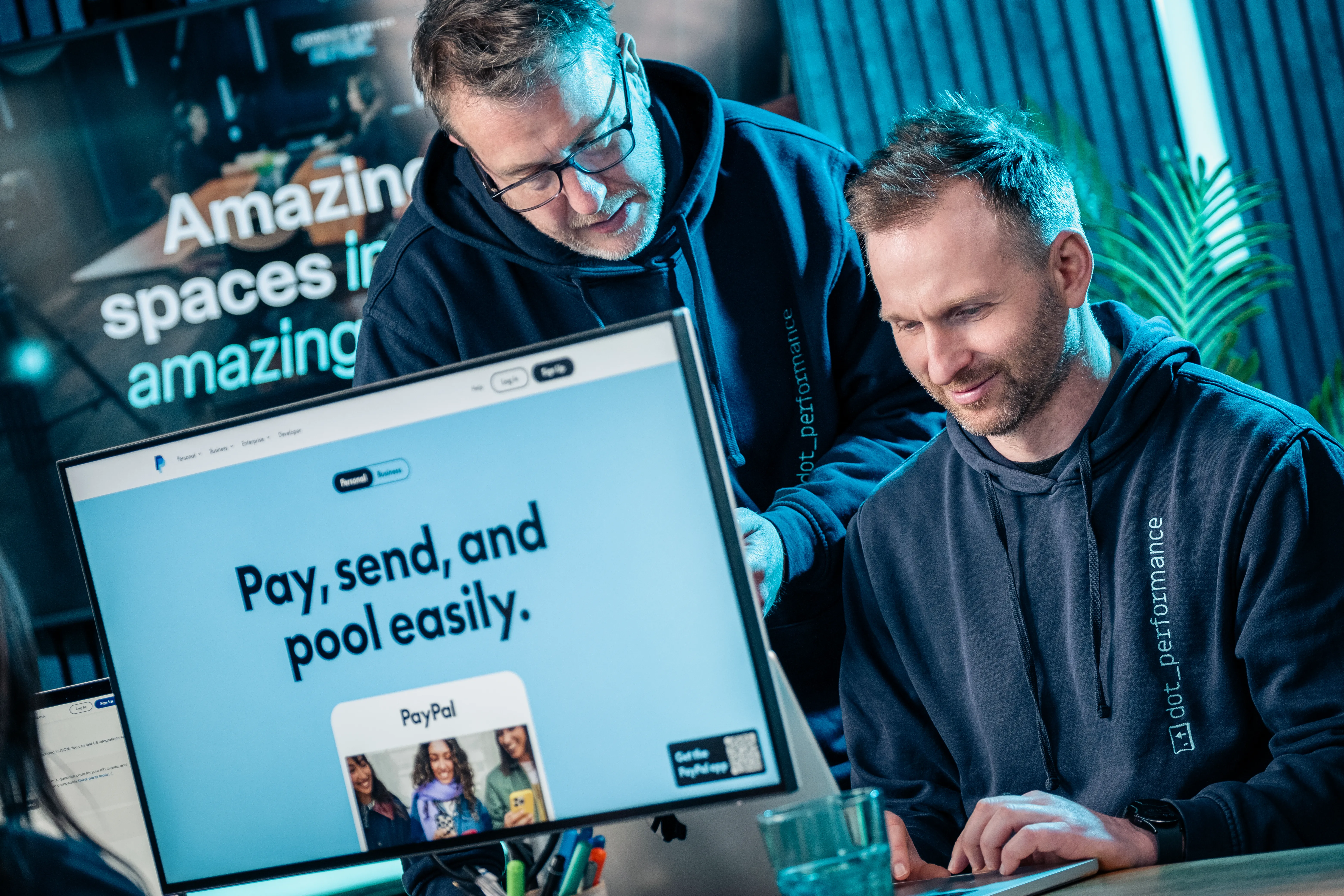 Simon King and John Beaty, DotPerformance team members, reviewing a website design on screen at the DotPerformance studio on the Isle of Man