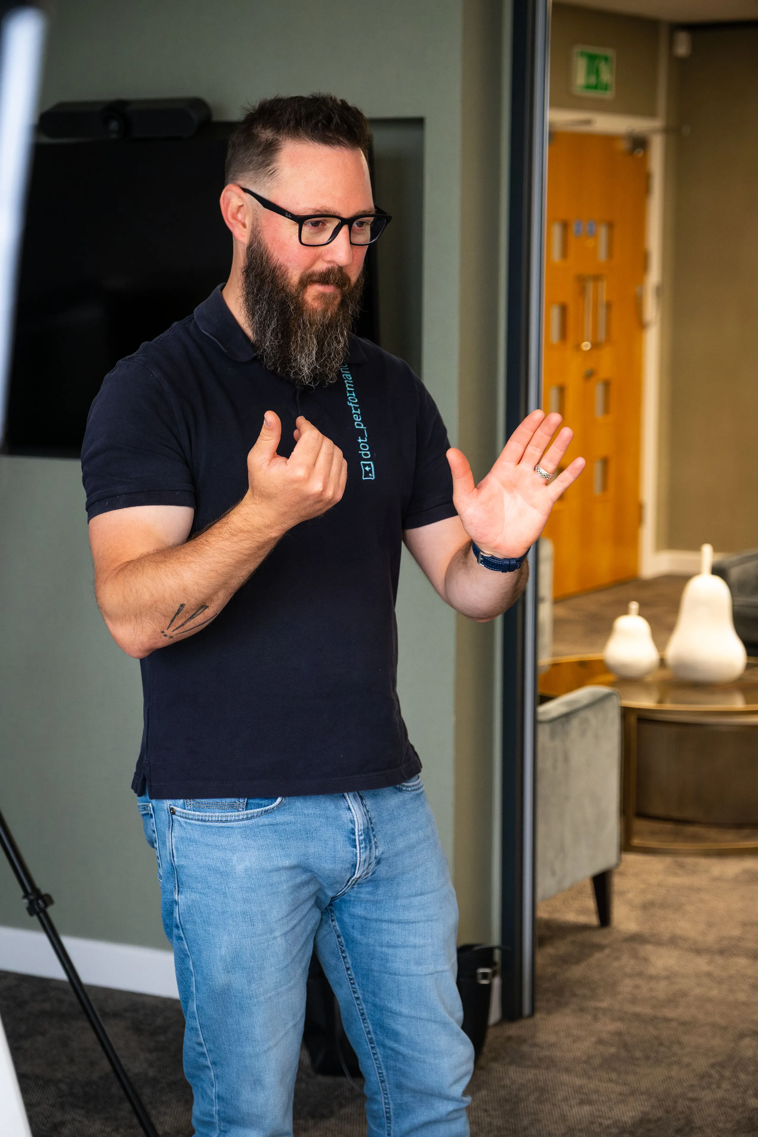 Nico van Loggerenberg gesturing for the subject to rotate during a Boal & Co portrait session