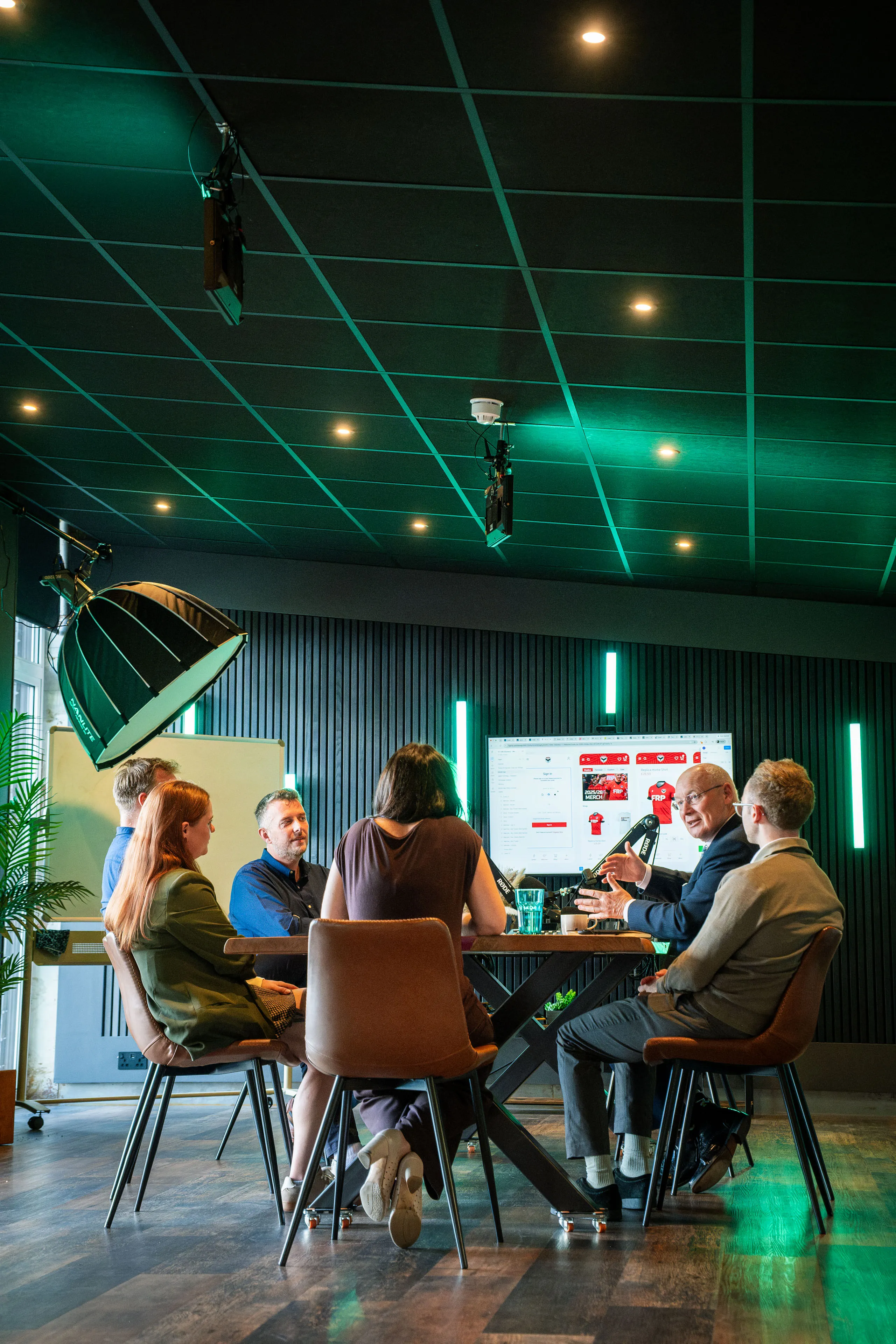 Wide view of the DotPerformance boardroom as the team gathers around Lieutenant General Sir John Lorimer KCB DSO MBE during his visit