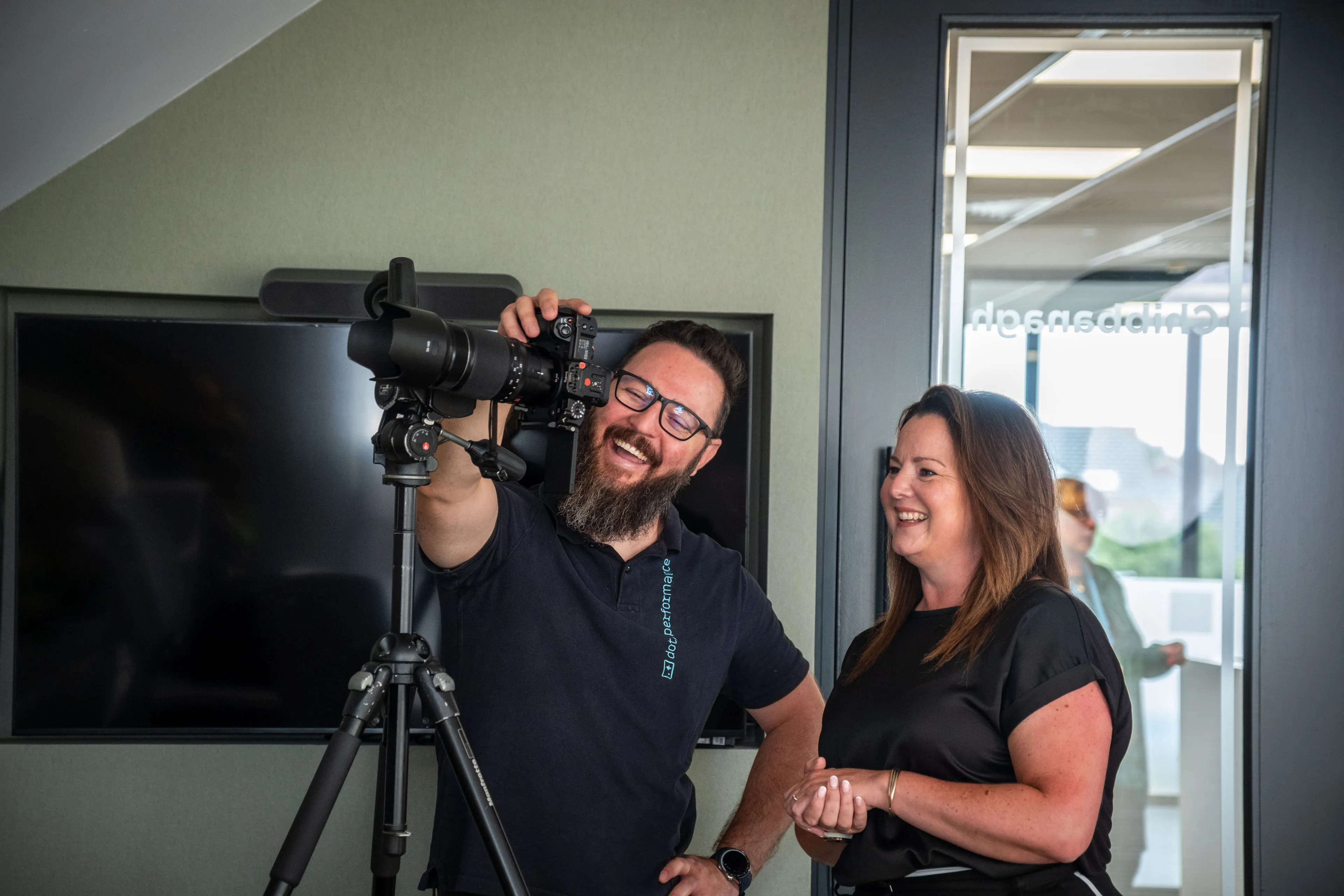 Nico van Loggerenberg and Karen Kelly, Group Director of Boal & Co, laughing while going through portraits during her session.