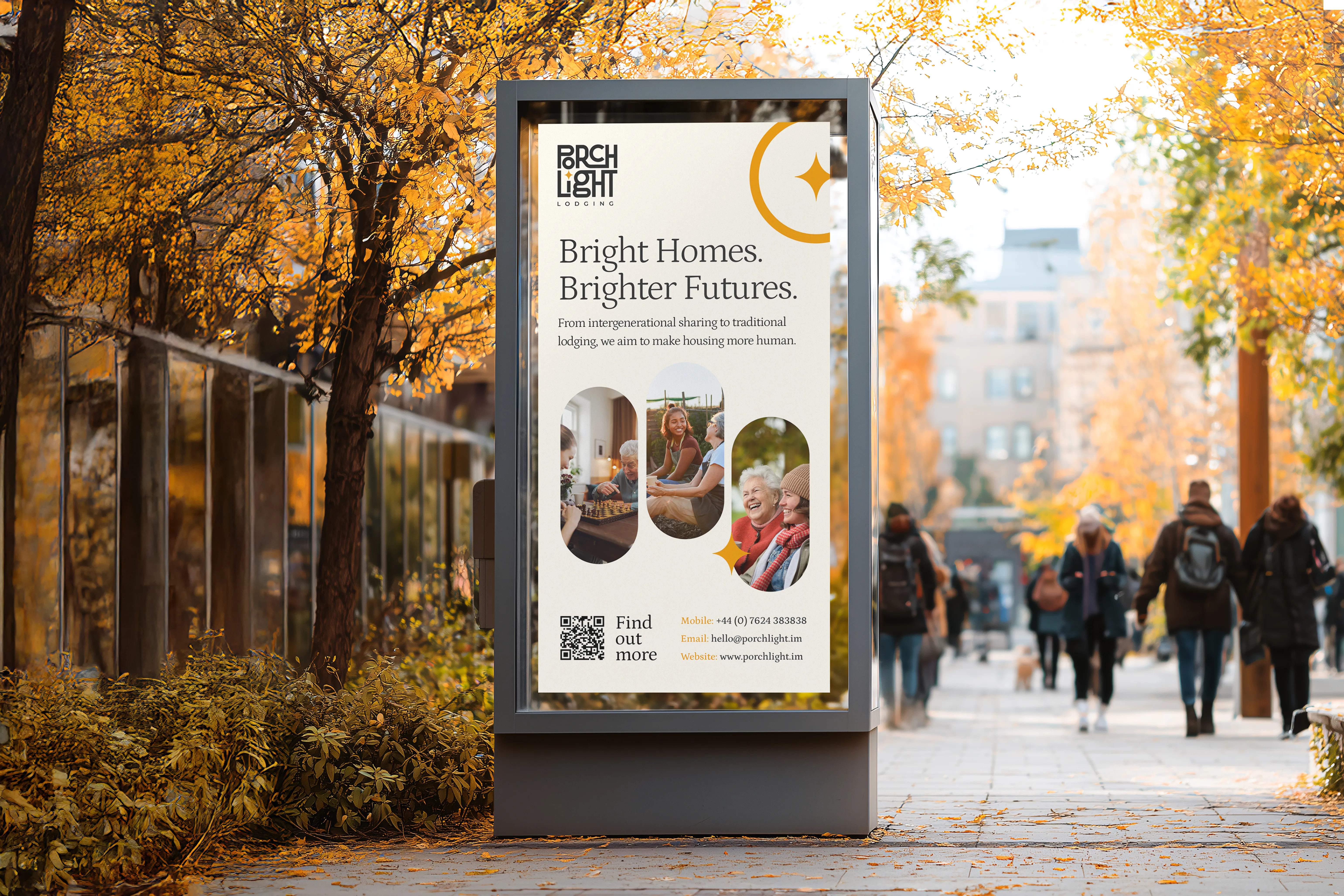 PorchLight Lodging Bright Homes. Brighter Futures. poster in an outdoor display case on a tree-lined street in autumn