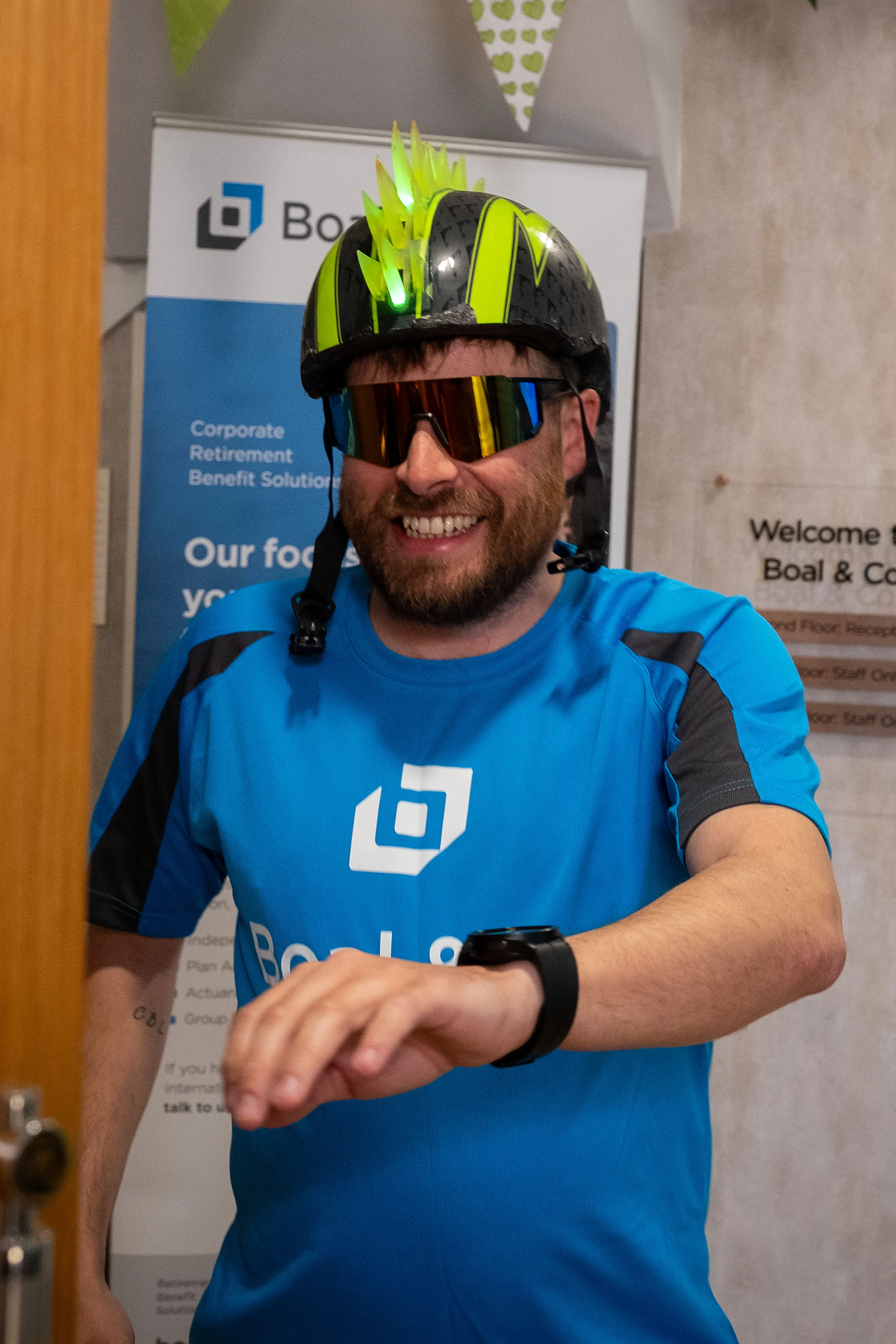 Andrew Cover in a Boal & Co cycling jersey and novelty spiked helmet at the Boal & Co office on the Isle of Man, ahead of the 12-hour charity cycling challenge